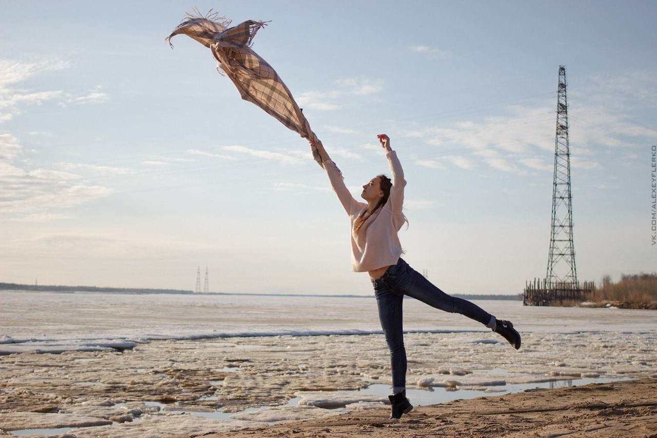 Woman with scarf jumping by frozen river HD Wallpaper