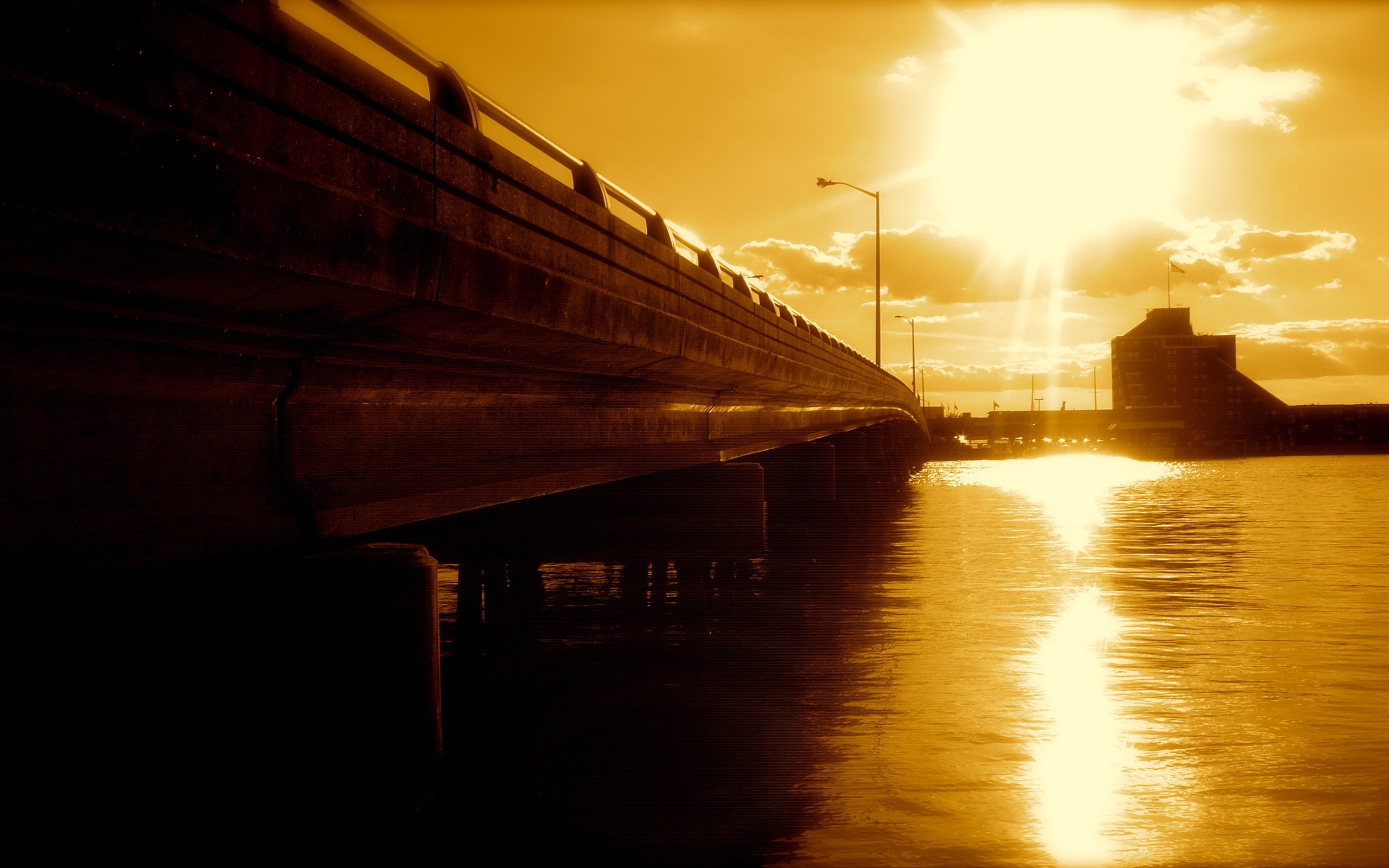 Bridge over water with sun reflection HD Wallpaper