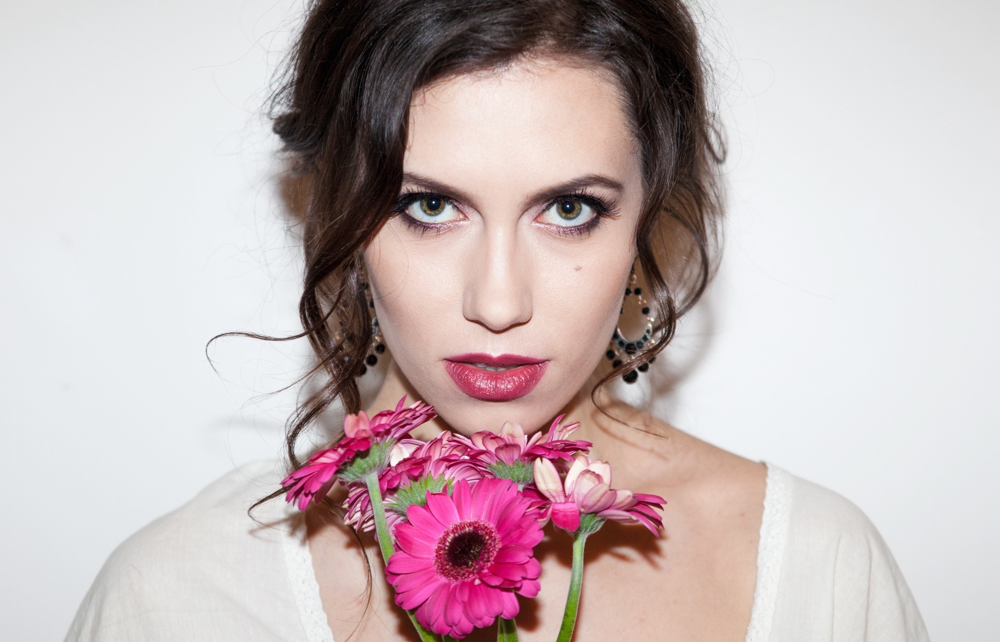 Woman with pink flowers and dark hair HD Wallpaper