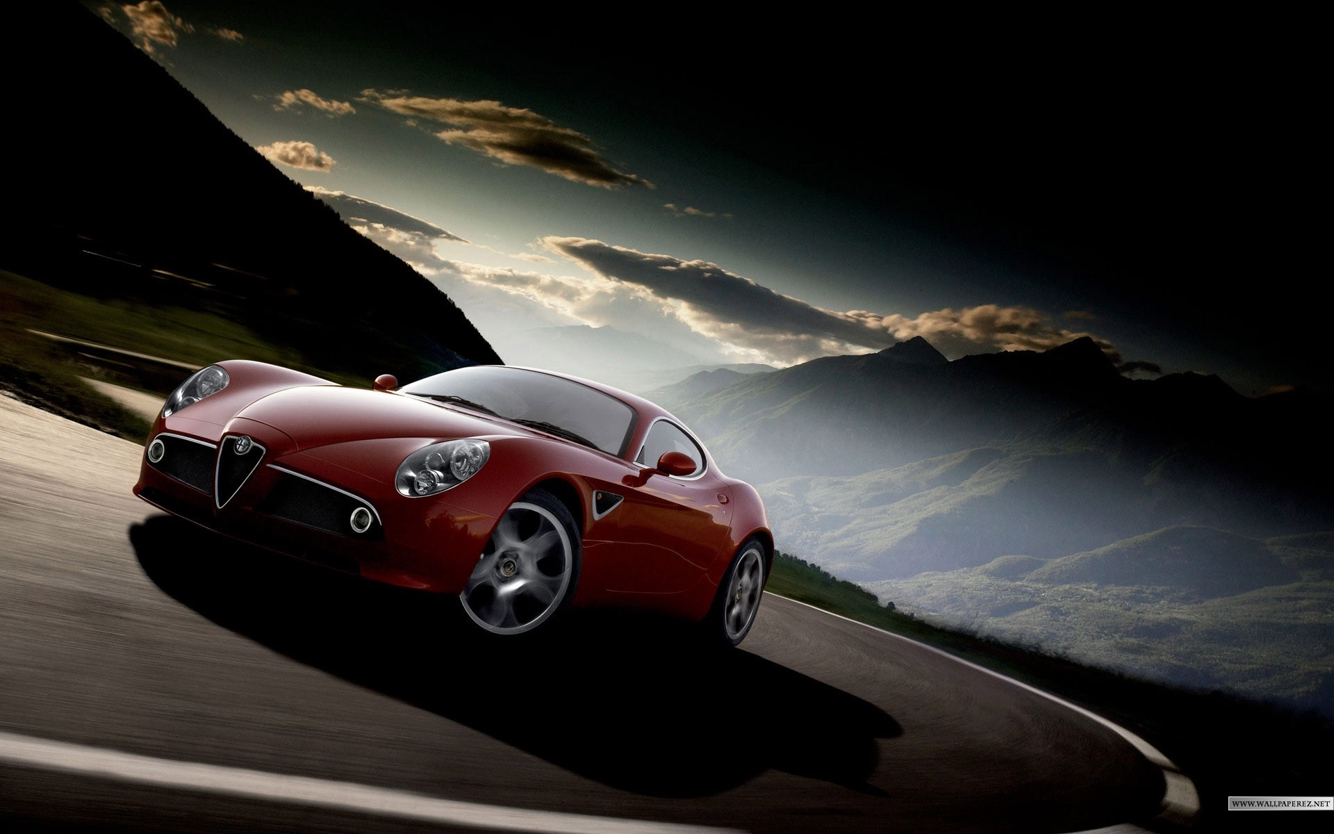 Red Alfa Romeo 8C driving on a mountain road HD Wallpaper