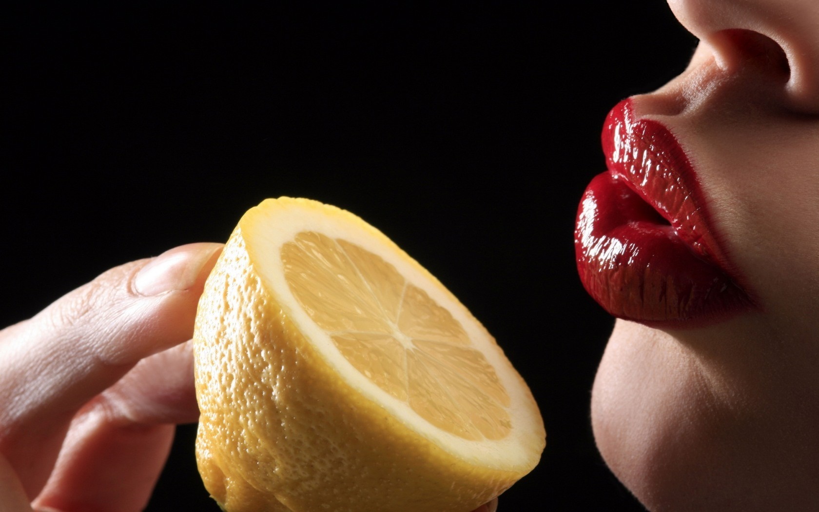 Woman's red lips near a lemon slice HD Wallpaper