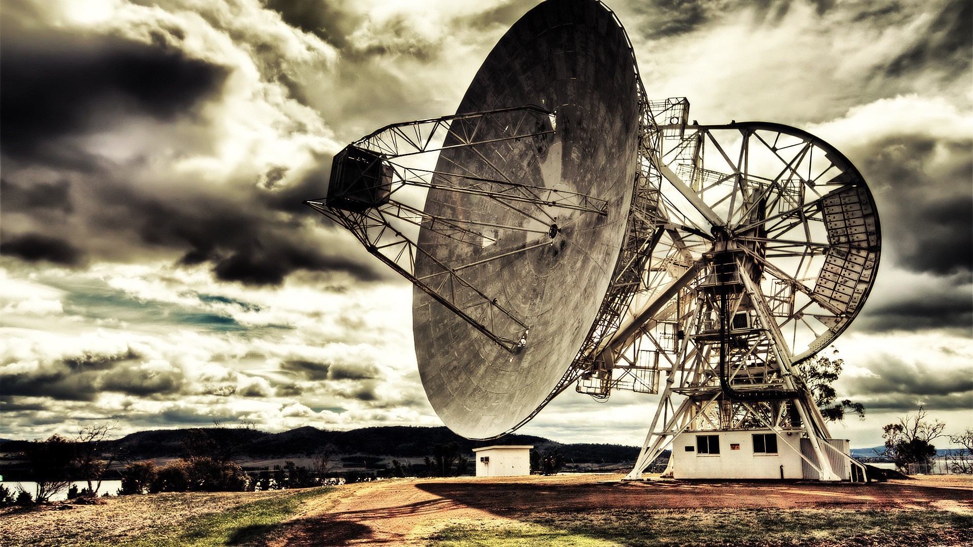 Radio telescope against a dramatic cloudy sky HD Wallpaper