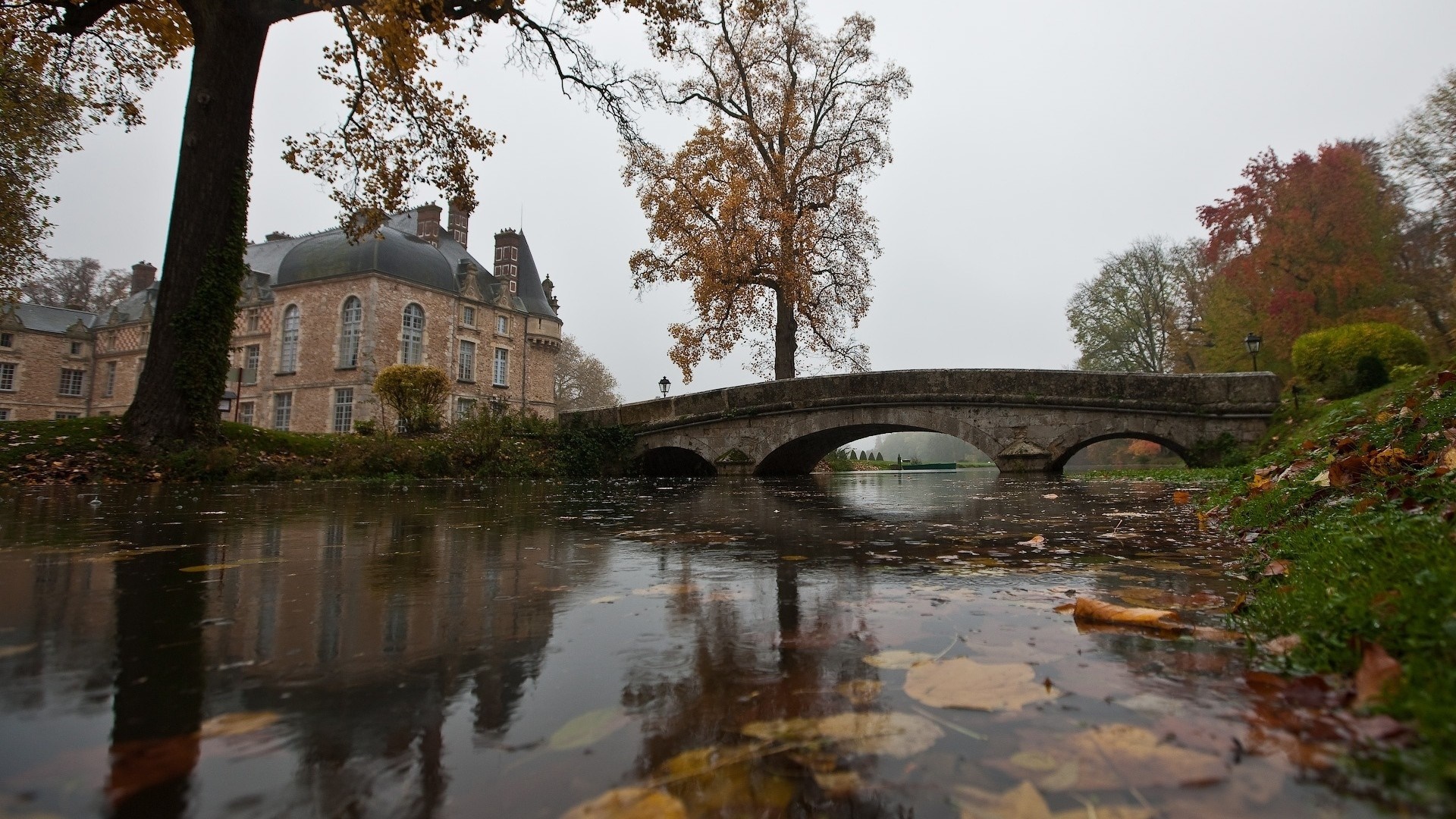 Castle with bridge over water in autumn HD Wallpaper