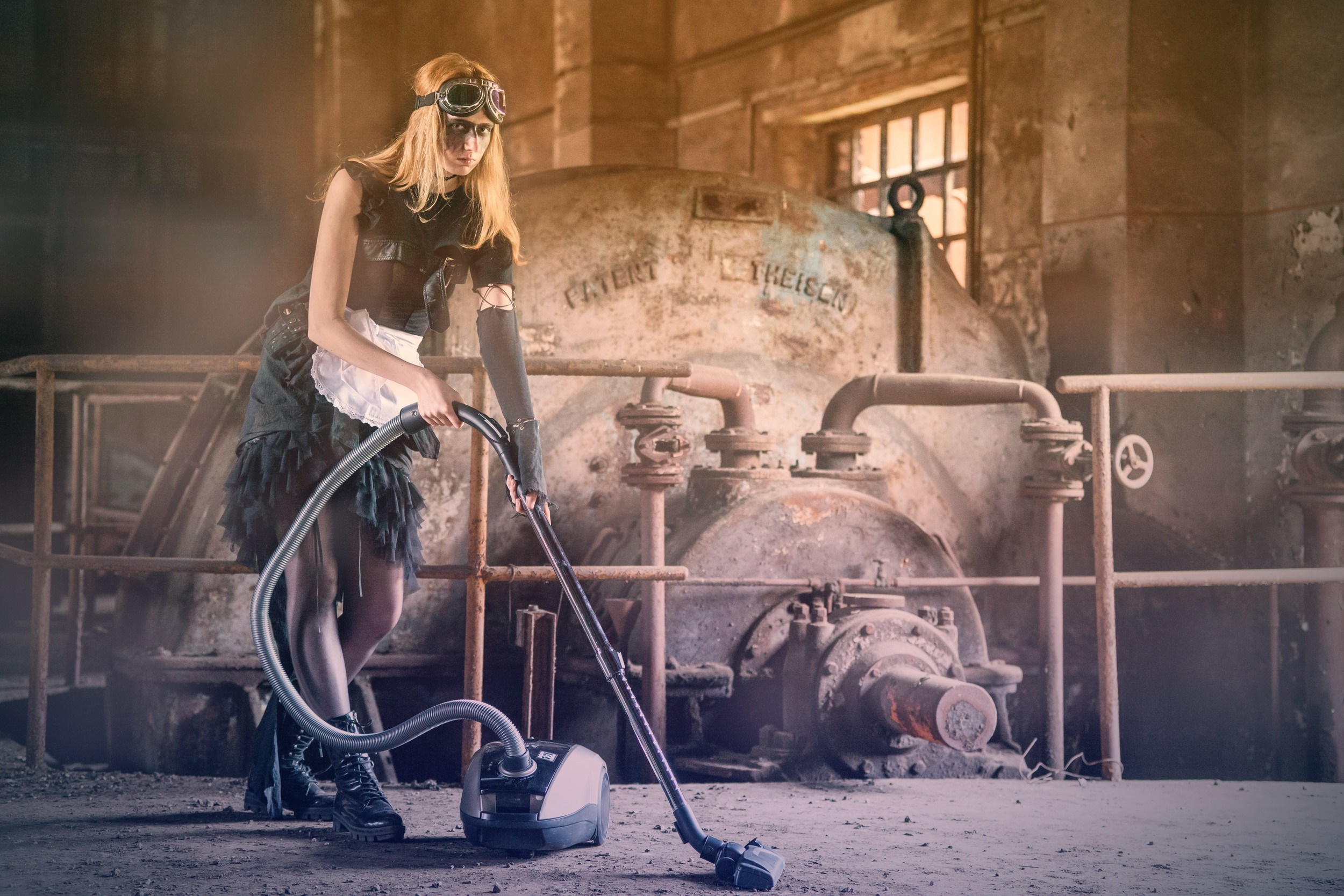 Woman in steampunk outfit vacuuming in abandoned factory HD Wallpaper