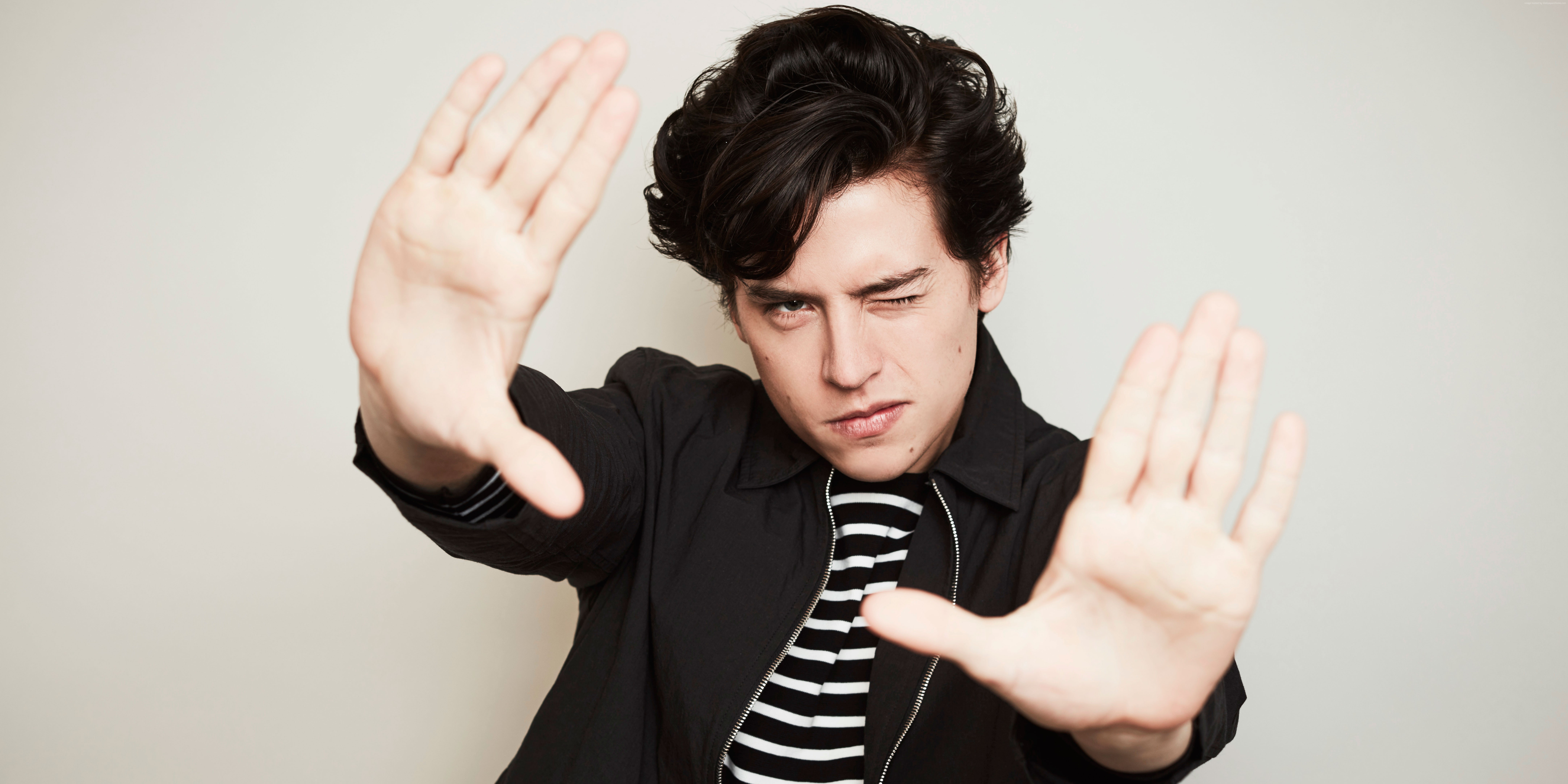 Cole Sprouse posing with hands up HD Wallpaper