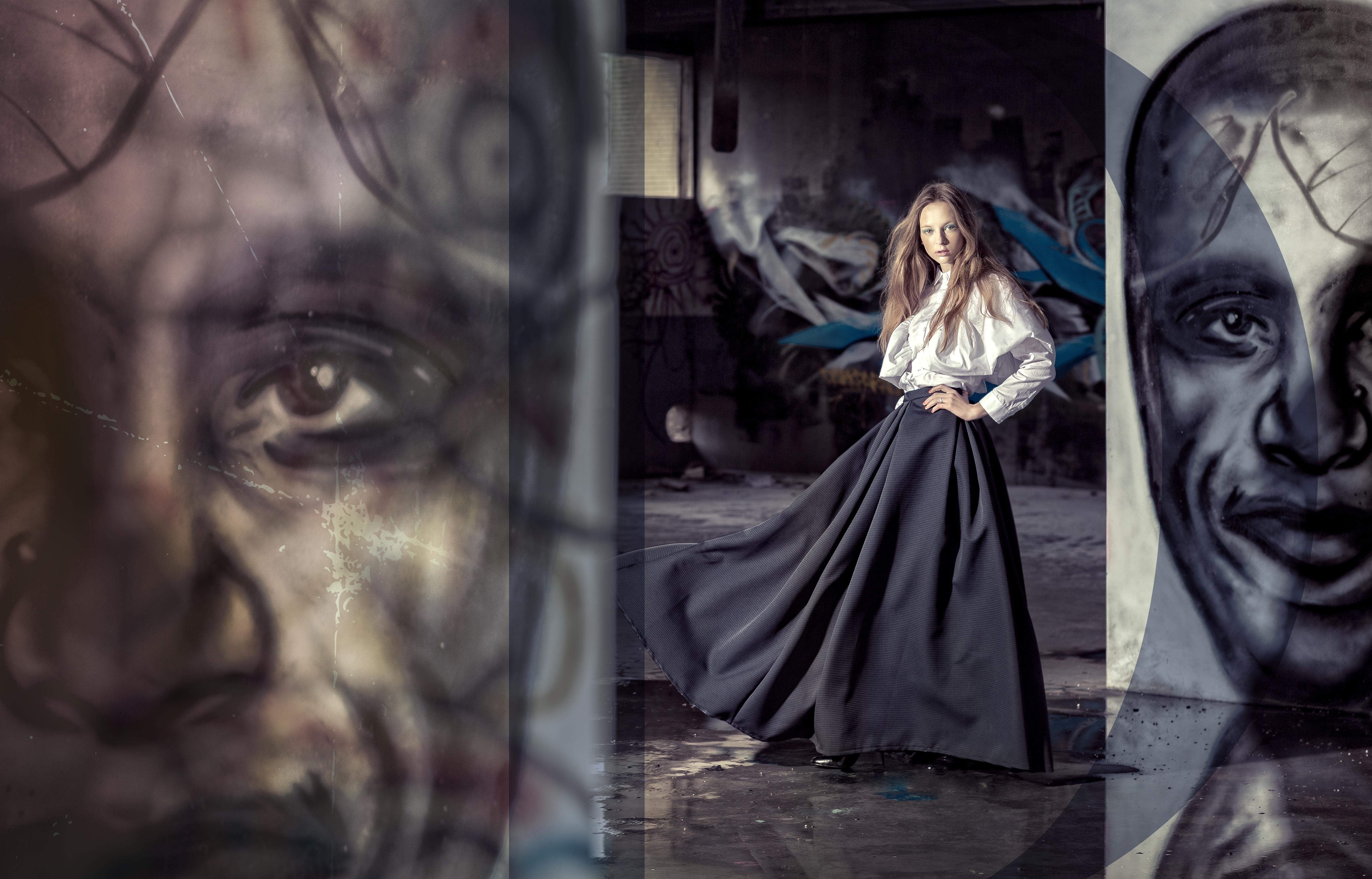 Woman in dark skirt and white shirt with graffiti art HD Wallpaper