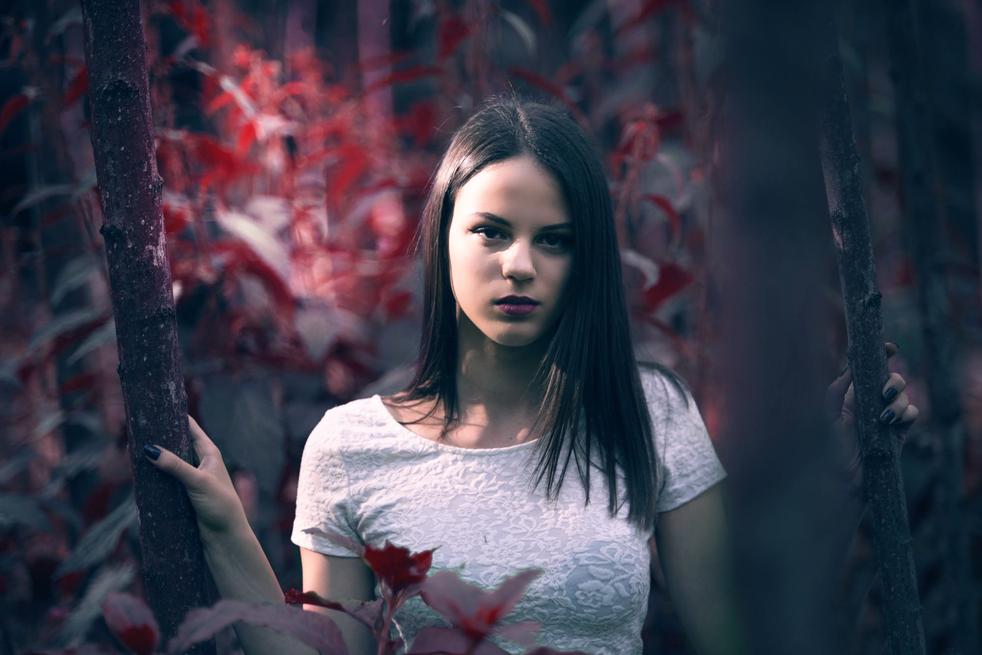 Woman in white top in a forest with red leaves HD Wallpaper