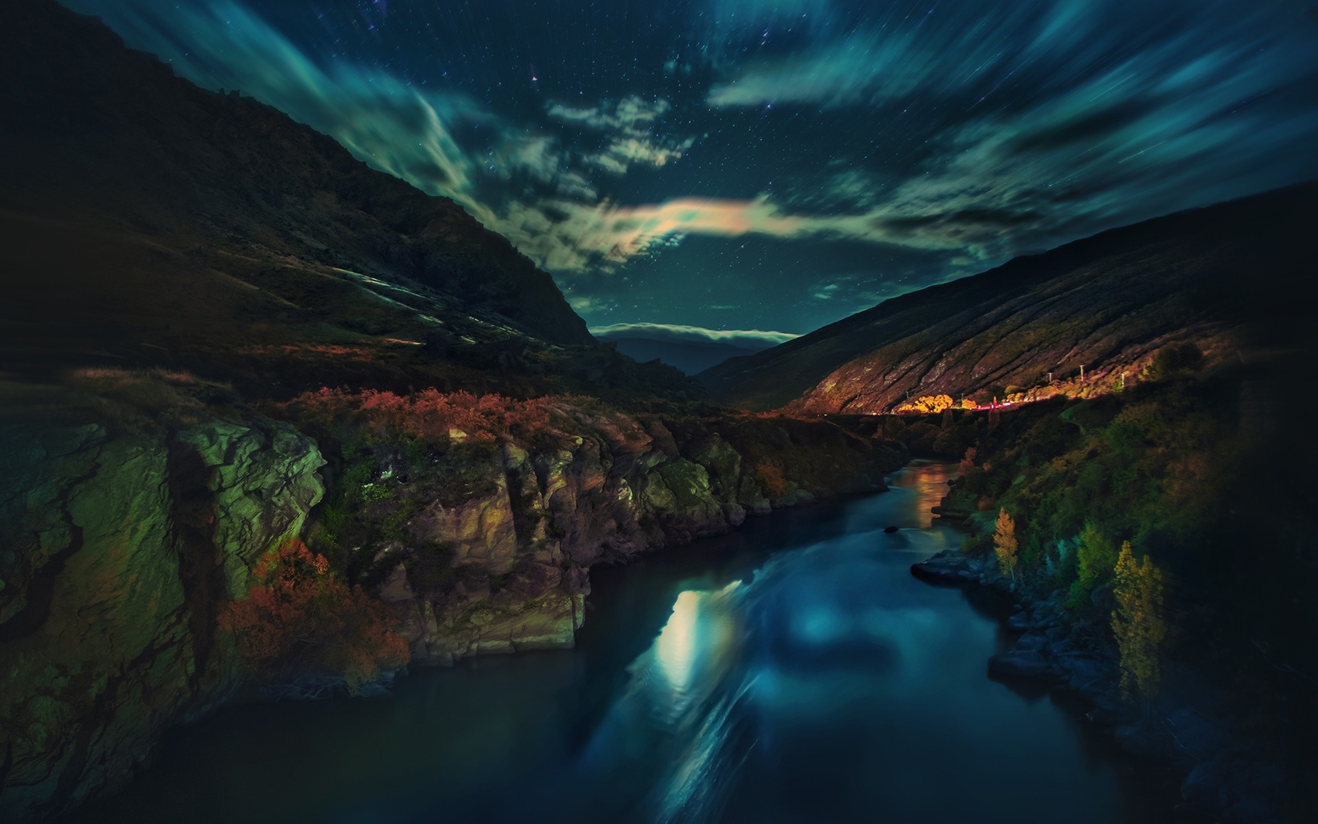 River flowing through mountains under a starry night sky HD Wallpaper