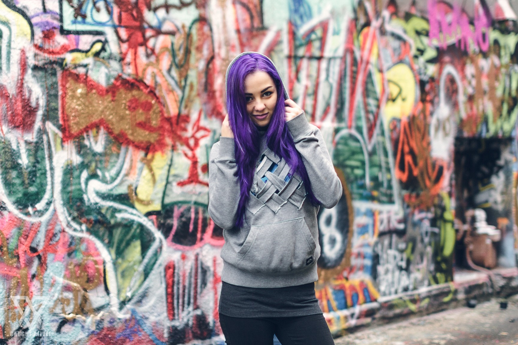 Woman with purple hair in front of graffiti wall HD Wallpaper