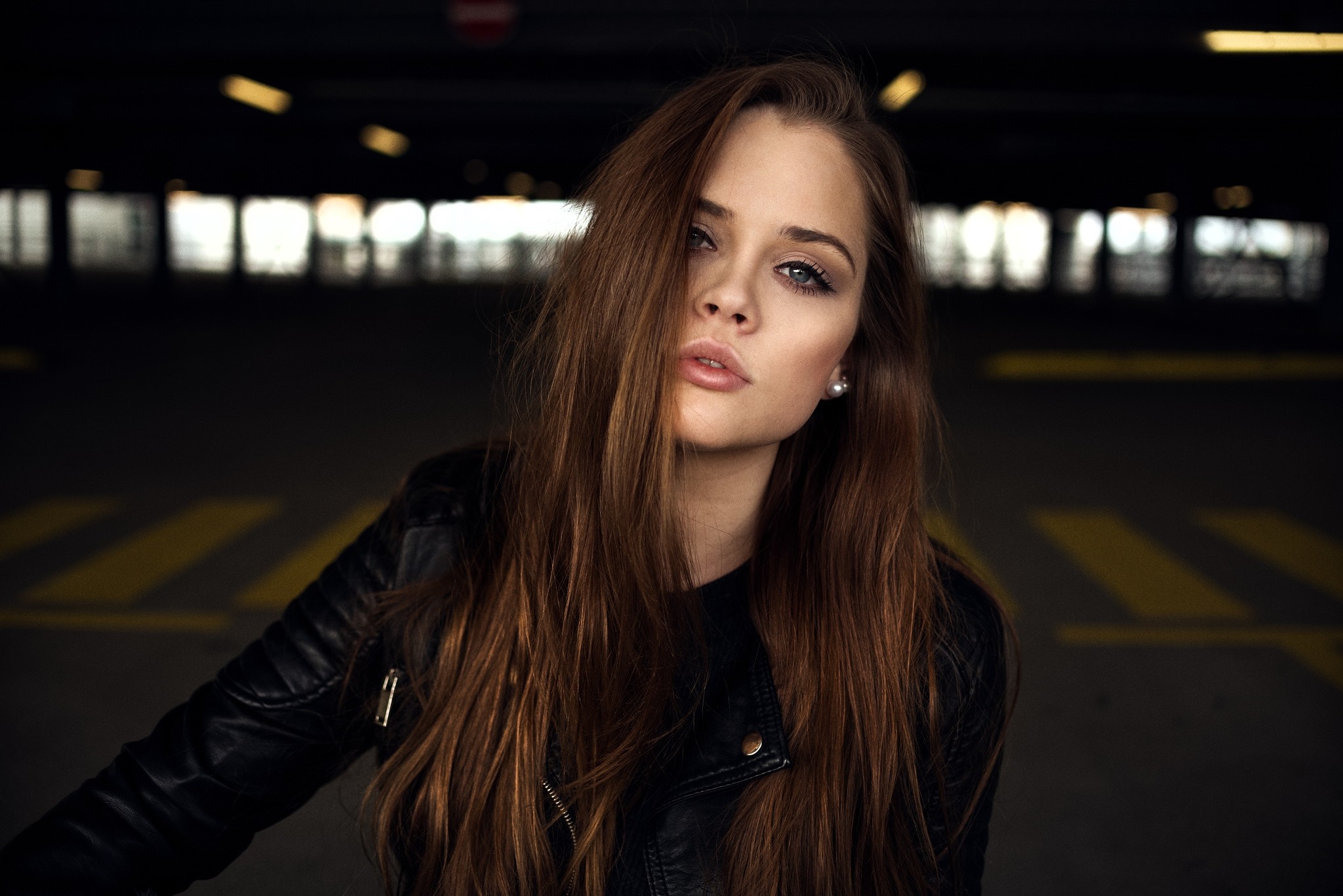 Woman with long brown hair wearing a leather jacket HD Wallpaper