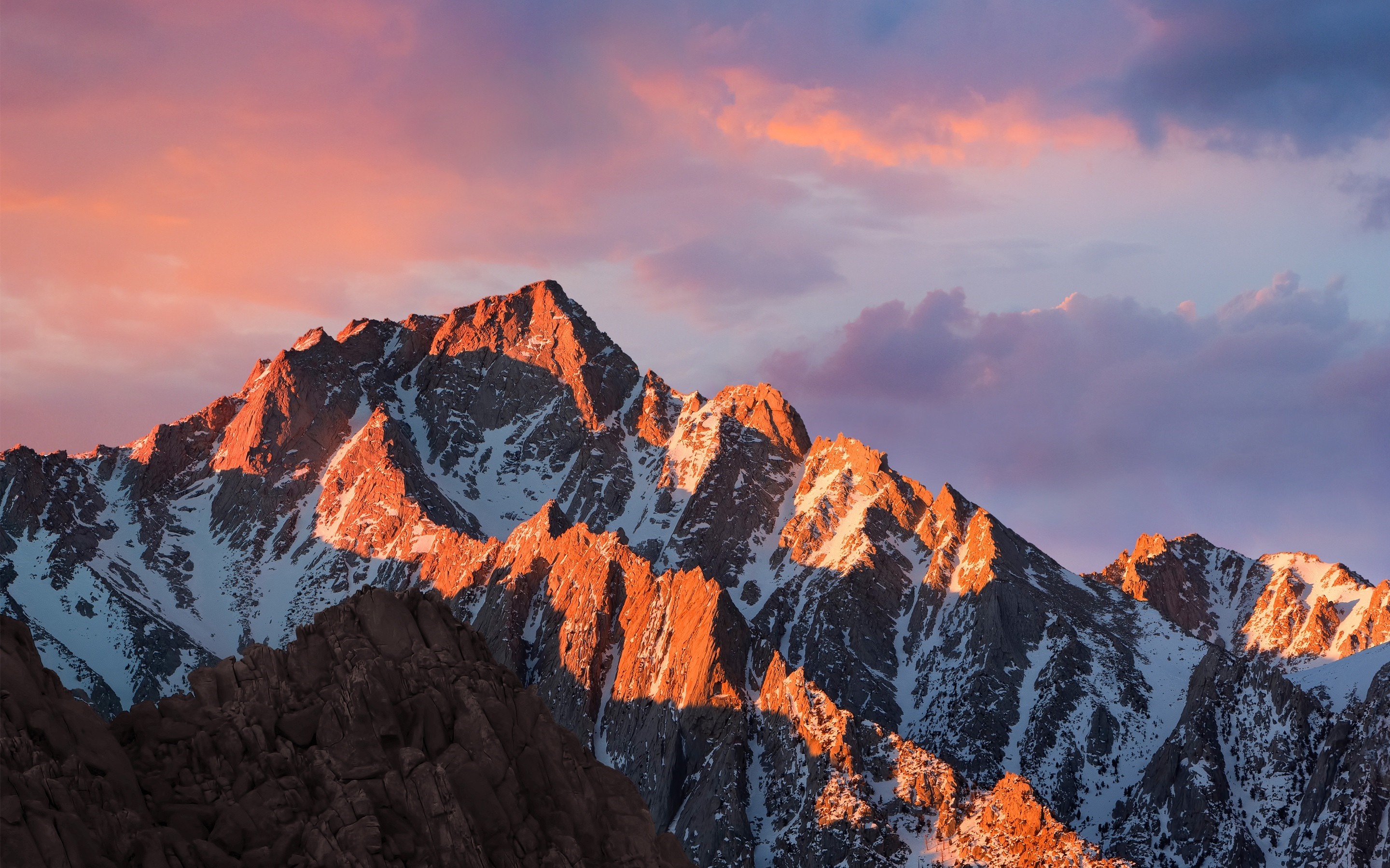 Snow-capped mountains at sunset with colorful clouds HD Wallpaper