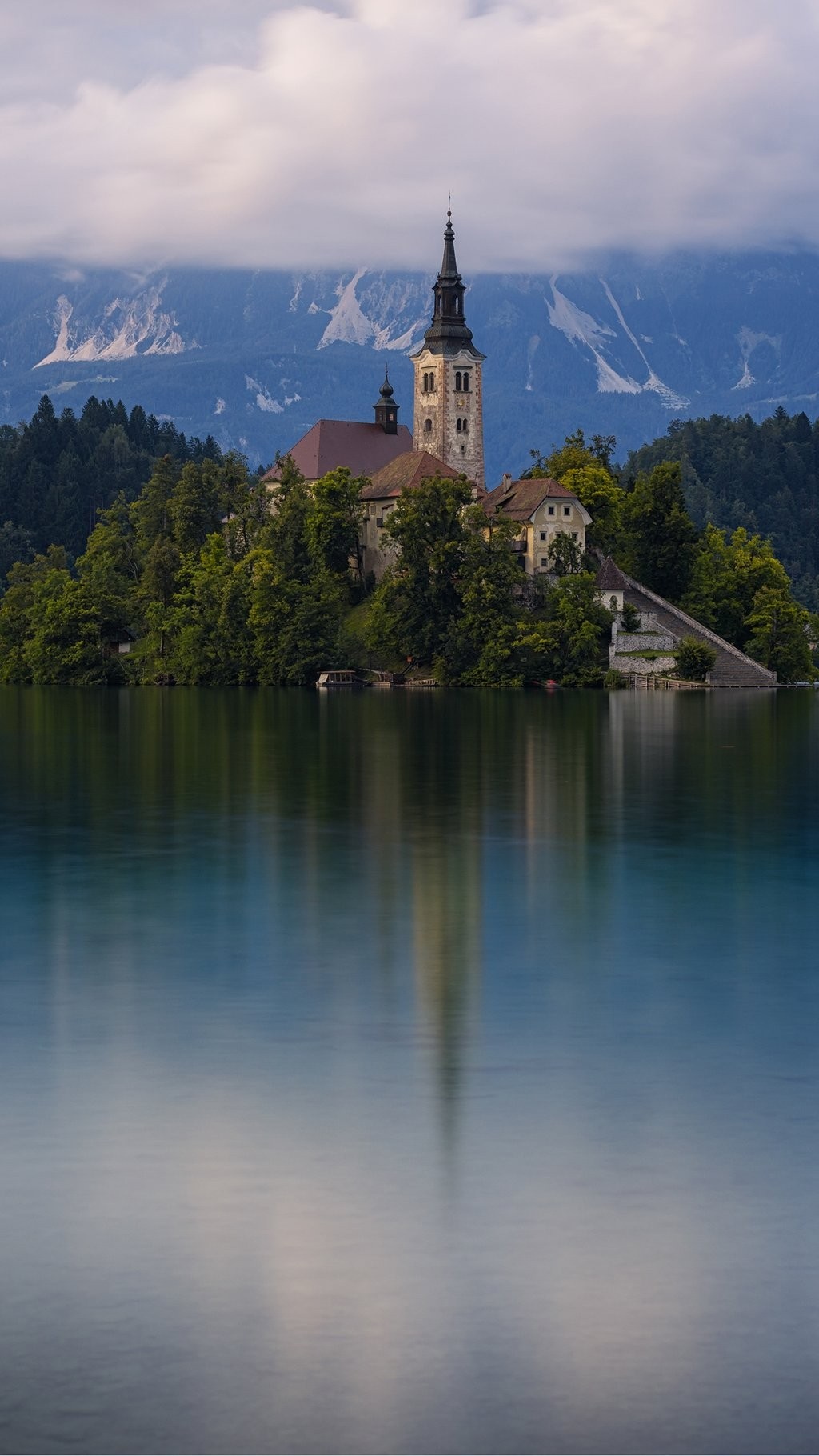 Church on an island in a lake with mountains HD Wallpaper