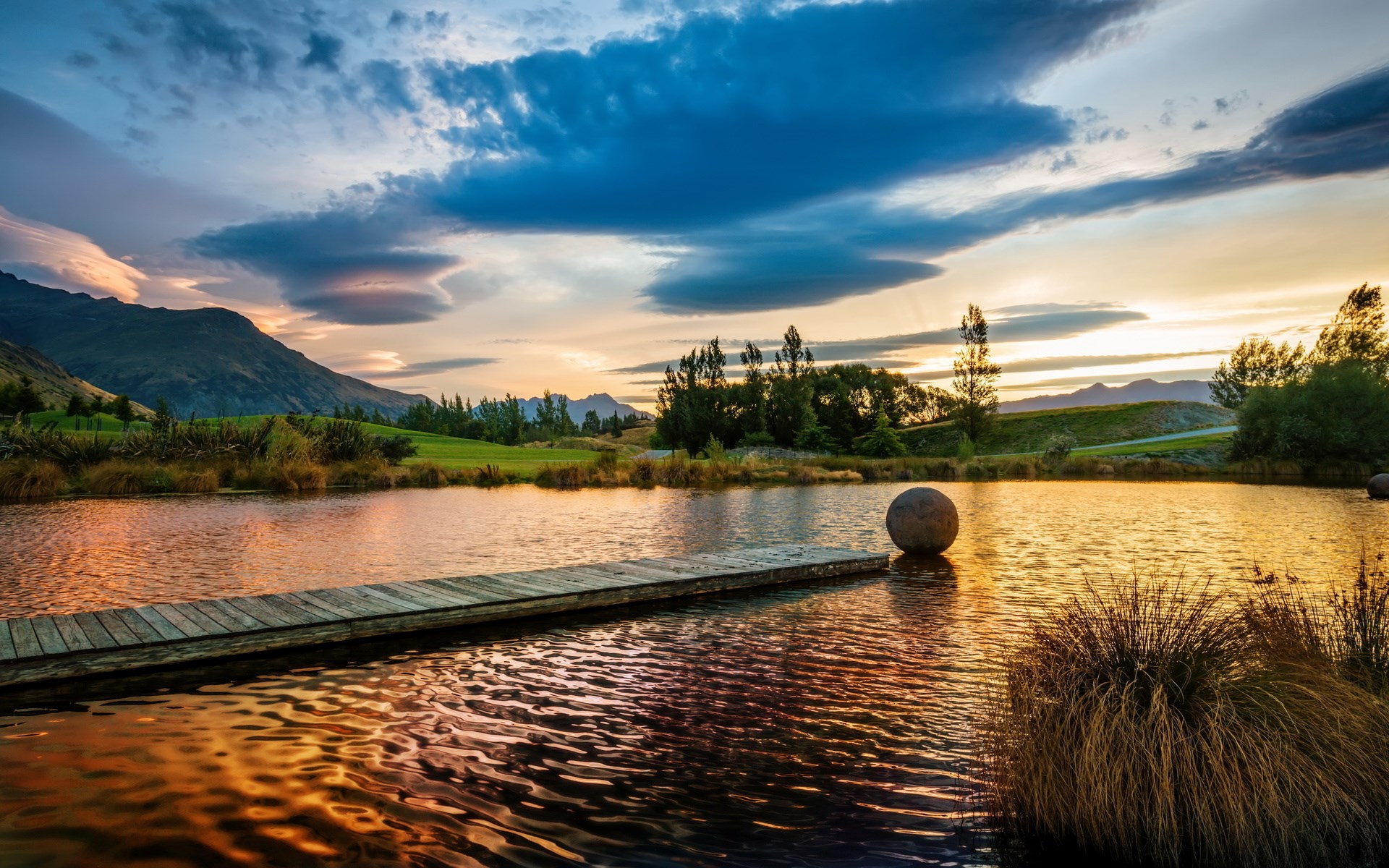 Wooden pier on a lake at sunset with mountains HD Wallpaper