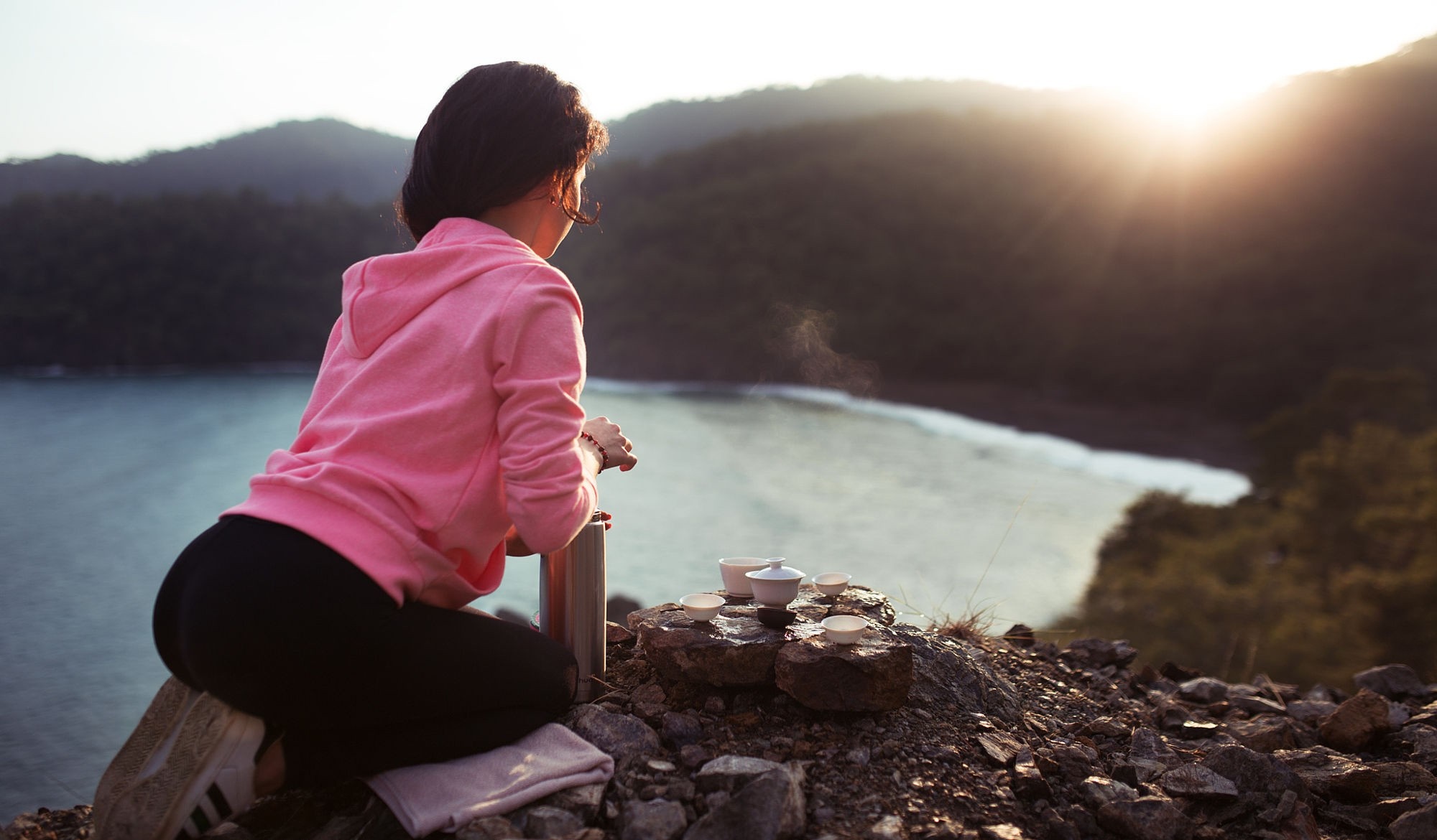 Woman having tea by the sea at sunrise HD Wallpaper