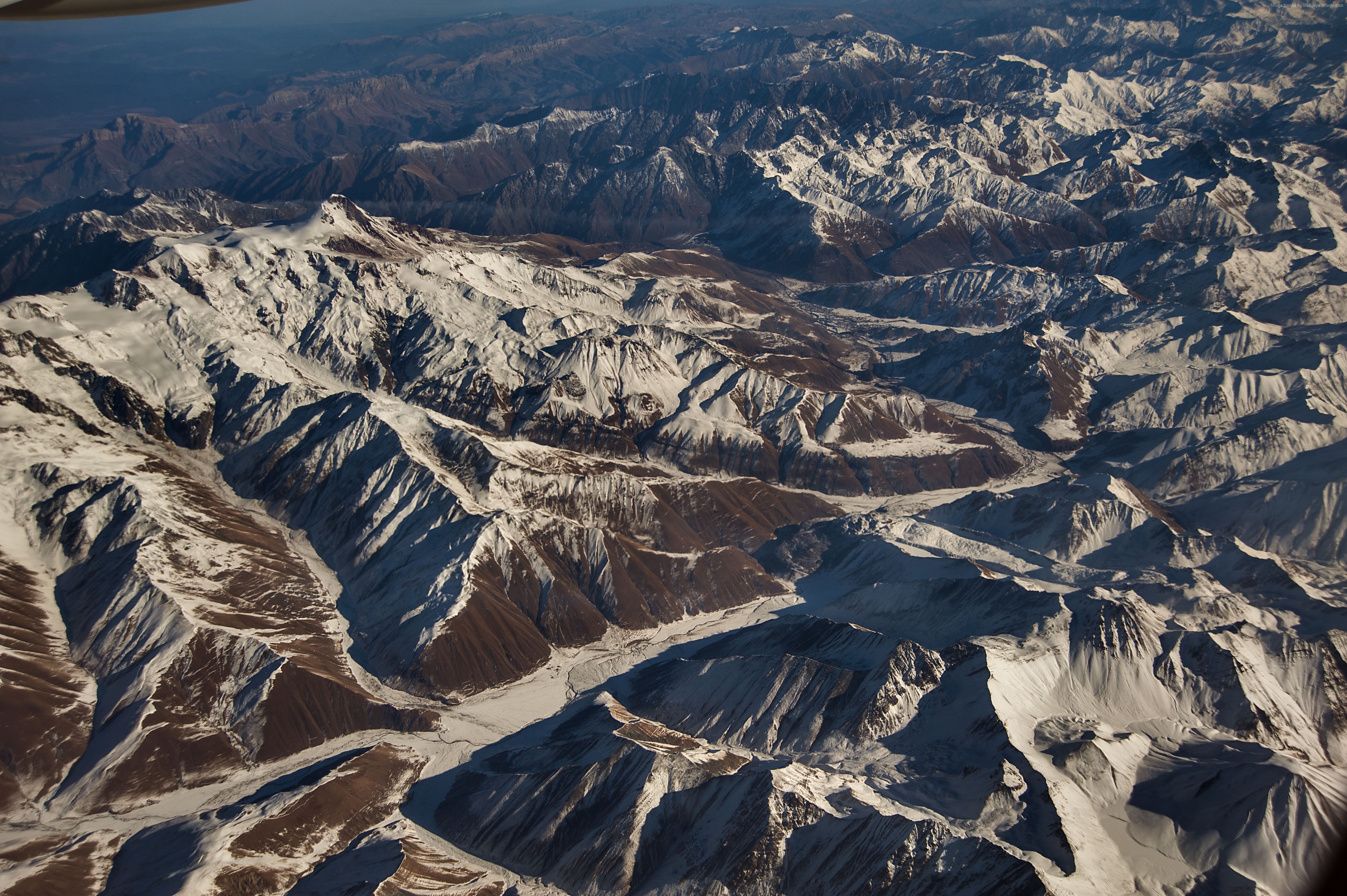 Aerial view of snow-capped Caucasus Mountains in 4K HD Wallpaper