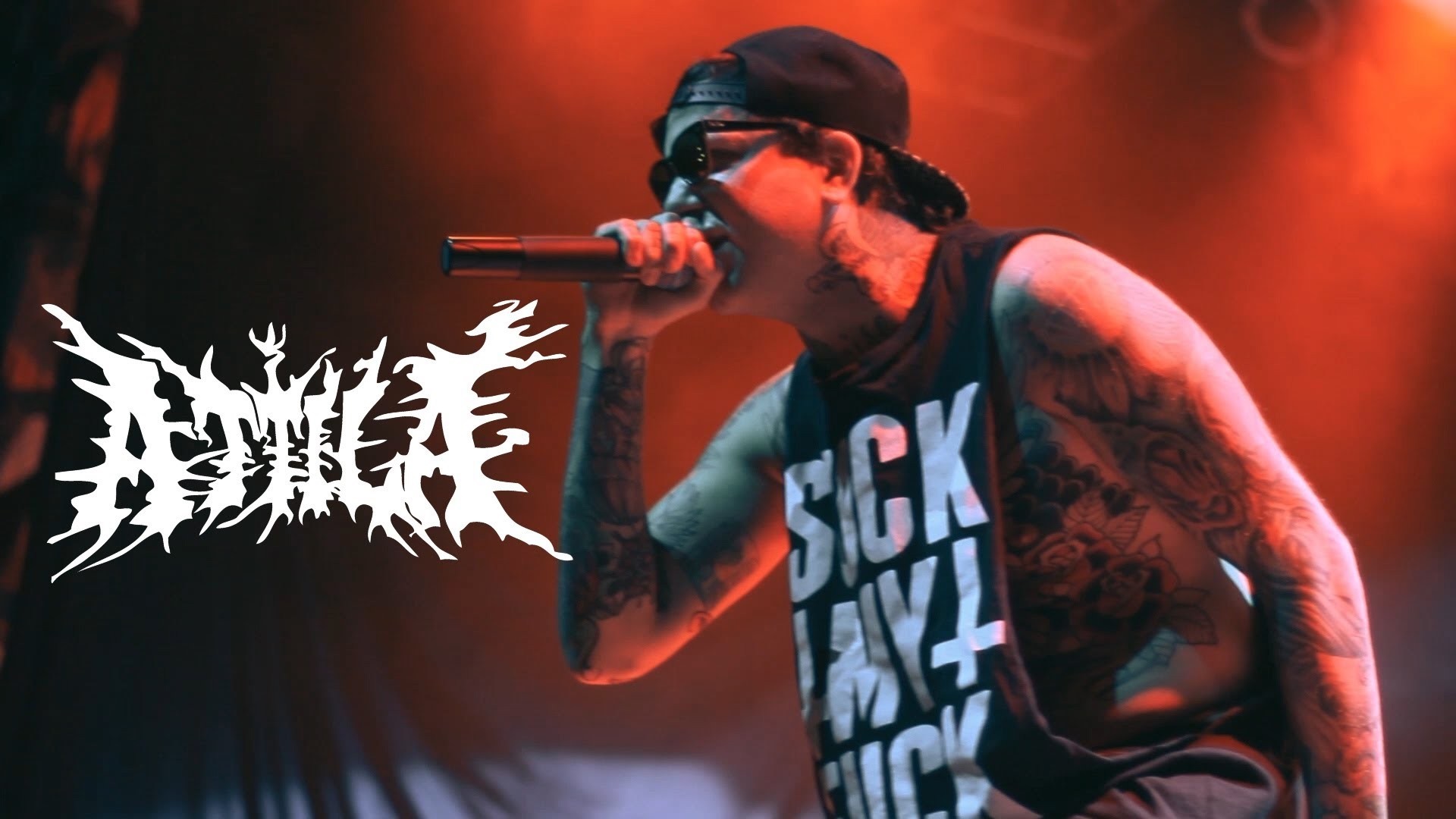 Attila band logo with singer performing on stage HD Wallpaper
