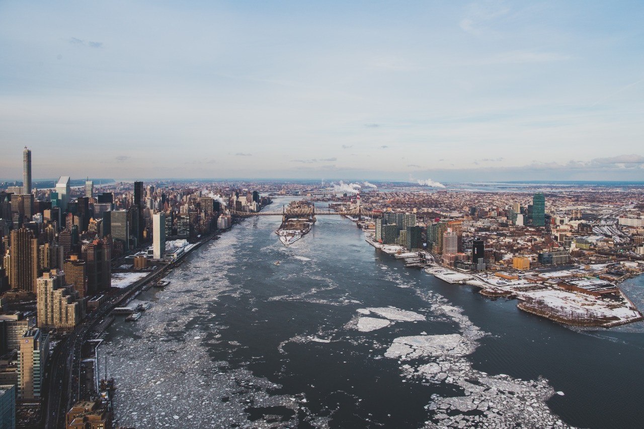 Aerial view of New York City skyline with icy river HD Wallpaper