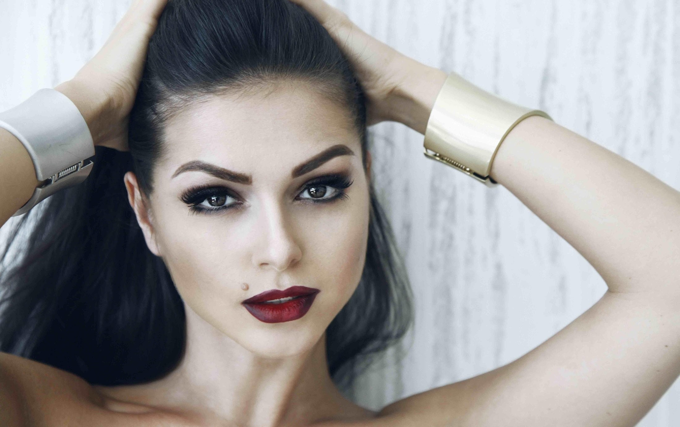 Woman with dark hair and bold makeup HD Wallpaper