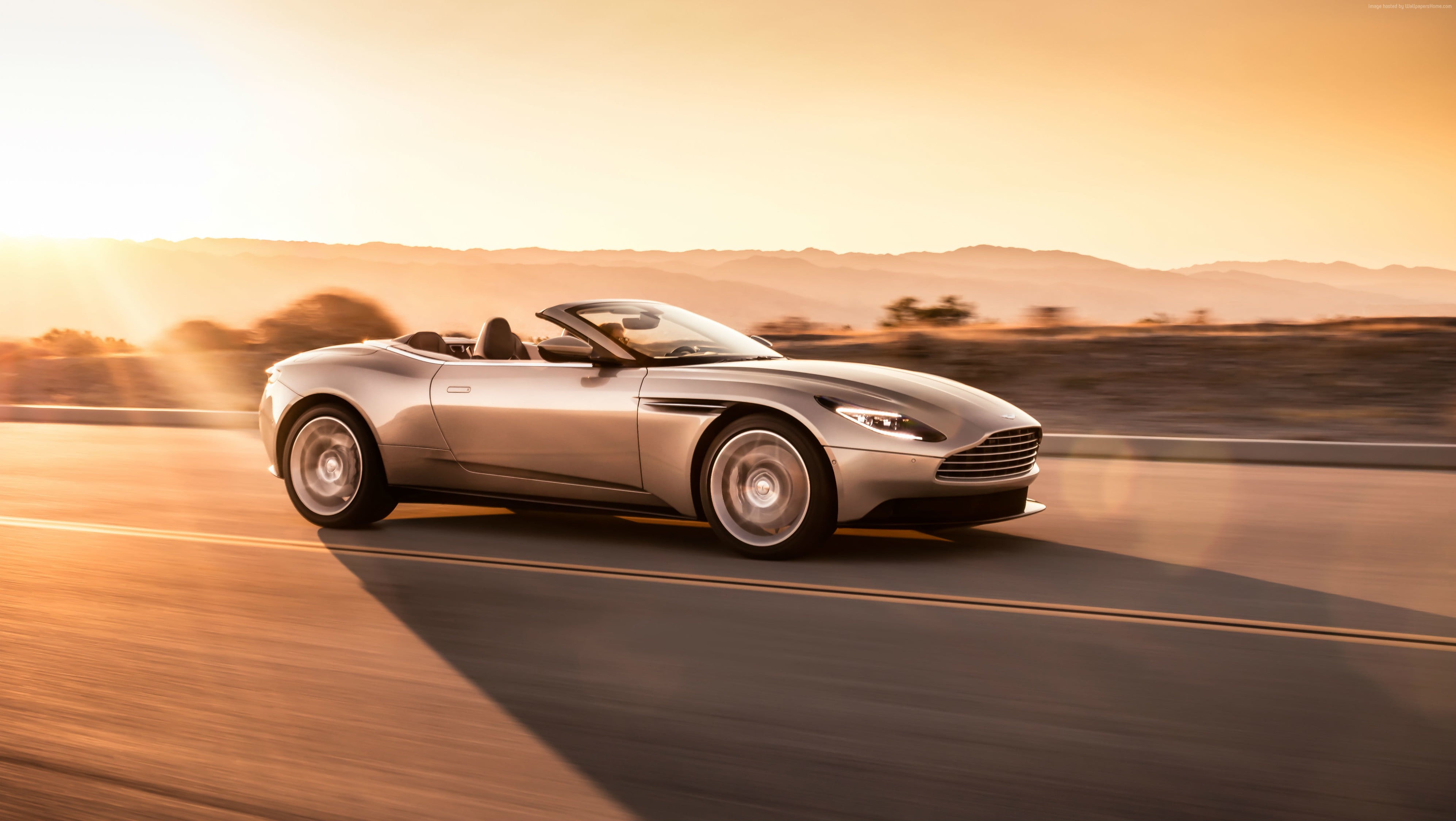 Aston Martin DB11 Volante convertible driving at sunset HD Wallpaper