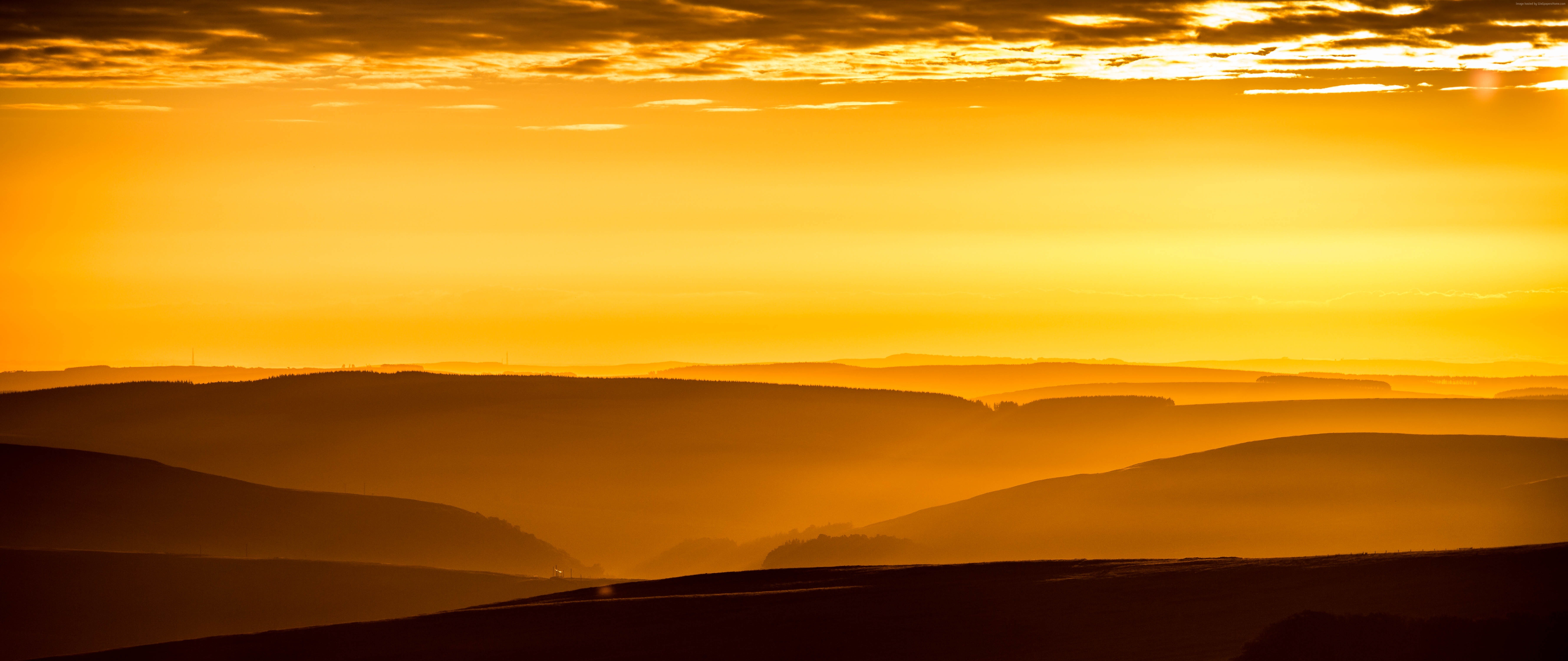 Golden sunrise over layered mountains HD Wallpaper