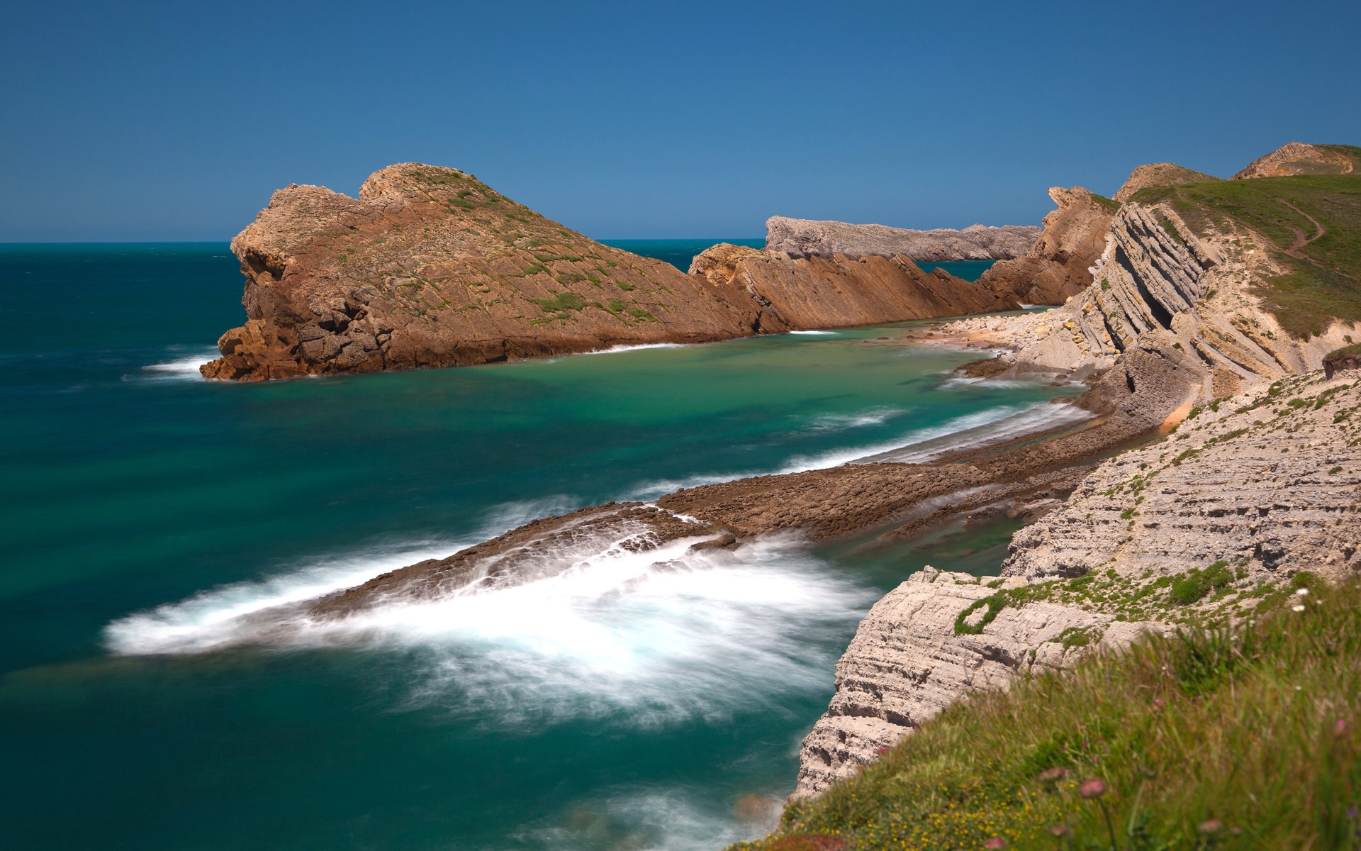 Coastal cliffs and turquoise water with waves HD Wallpaper