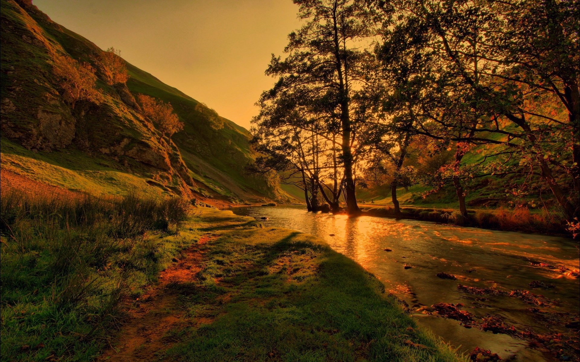 River flowing through a valley at sunset HD Wallpaper