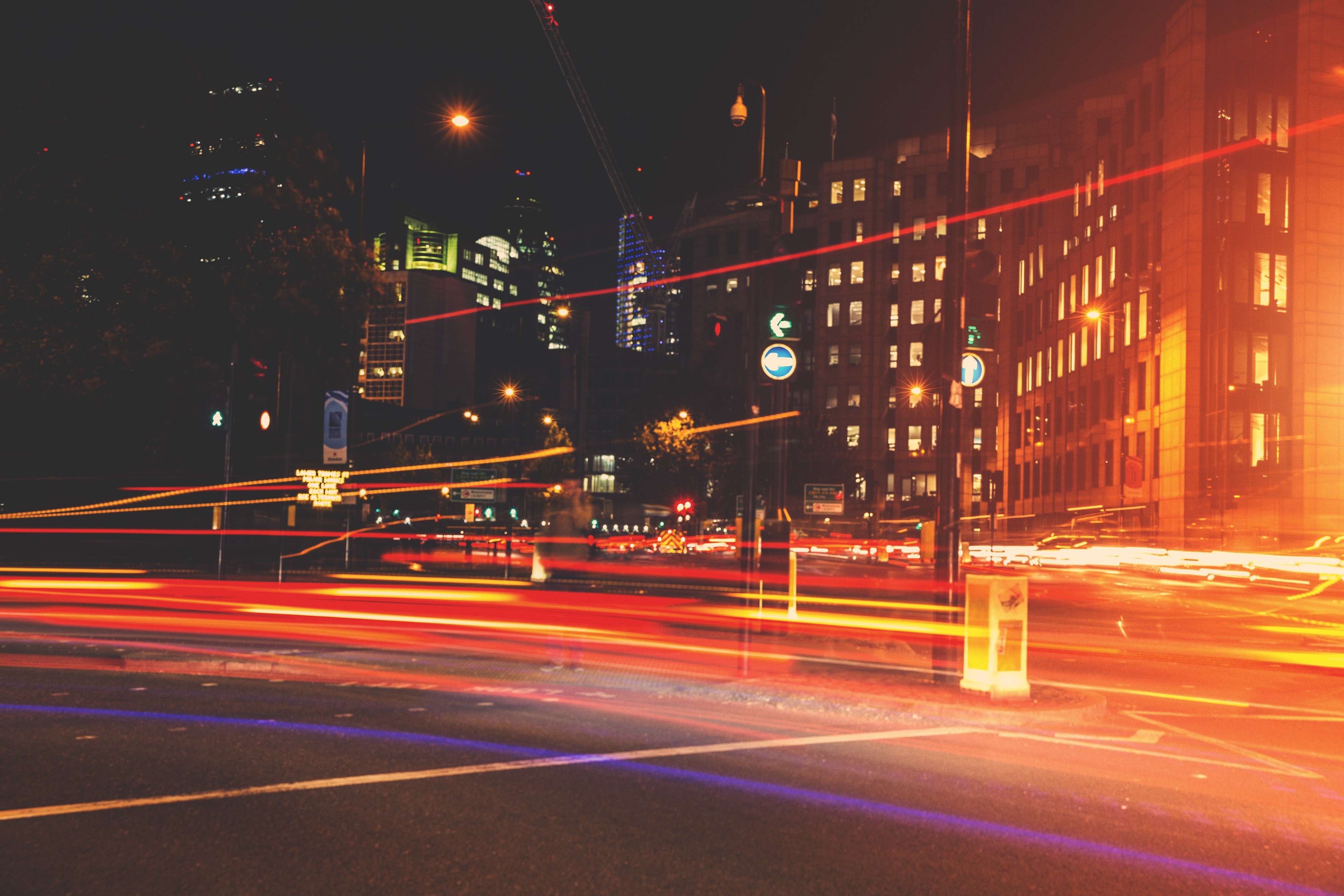 City street at night with light trails from traffic HD Wallpaper