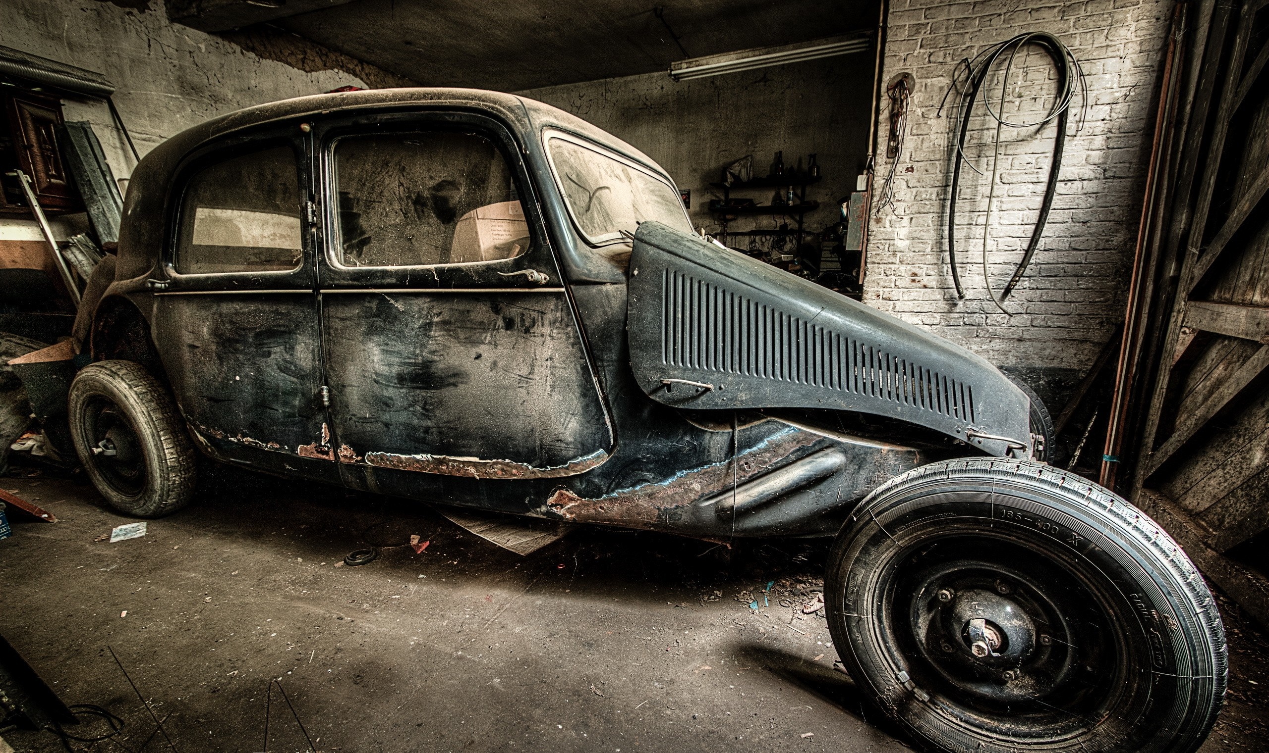 Abandoned vintage car in a dusty garage HD Wallpaper