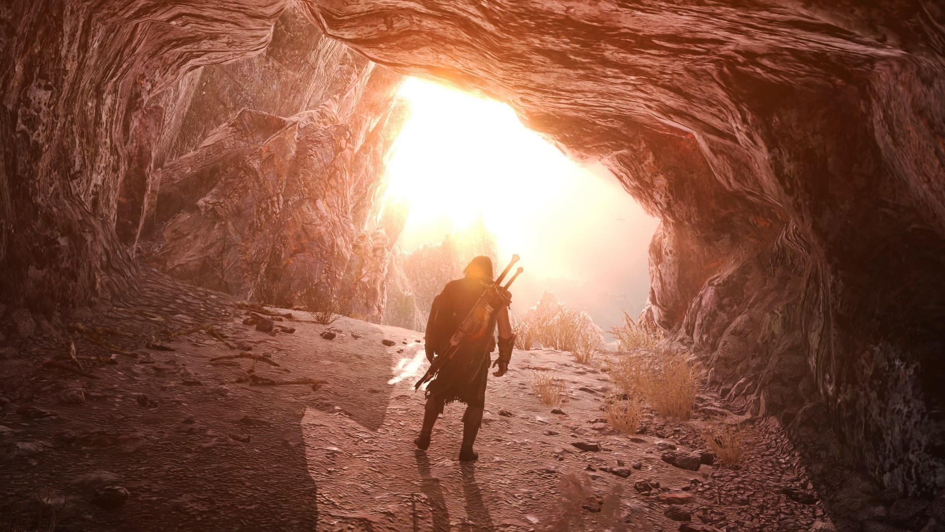 Man with swords exiting a cave into sunlight HD Wallpaper