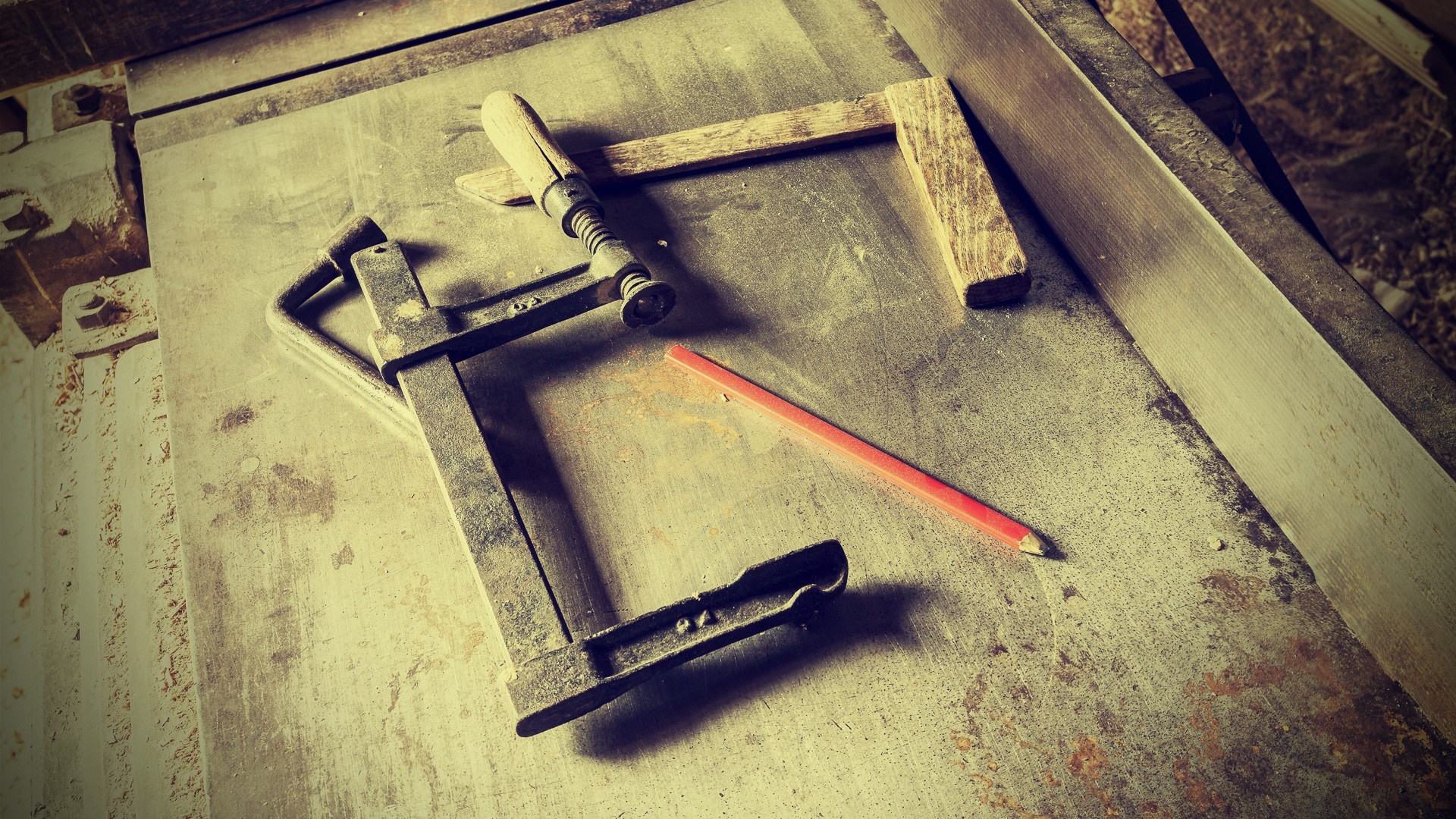 Carpenter's clamp and pencil on a workbench HD Wallpaper