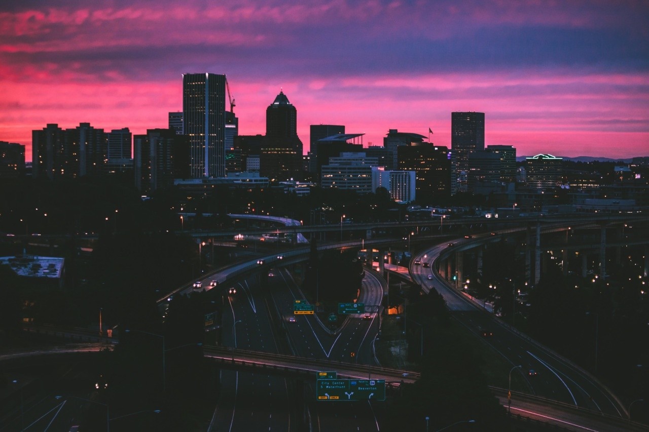 Cityscape at sunset with highways HD Wallpaper