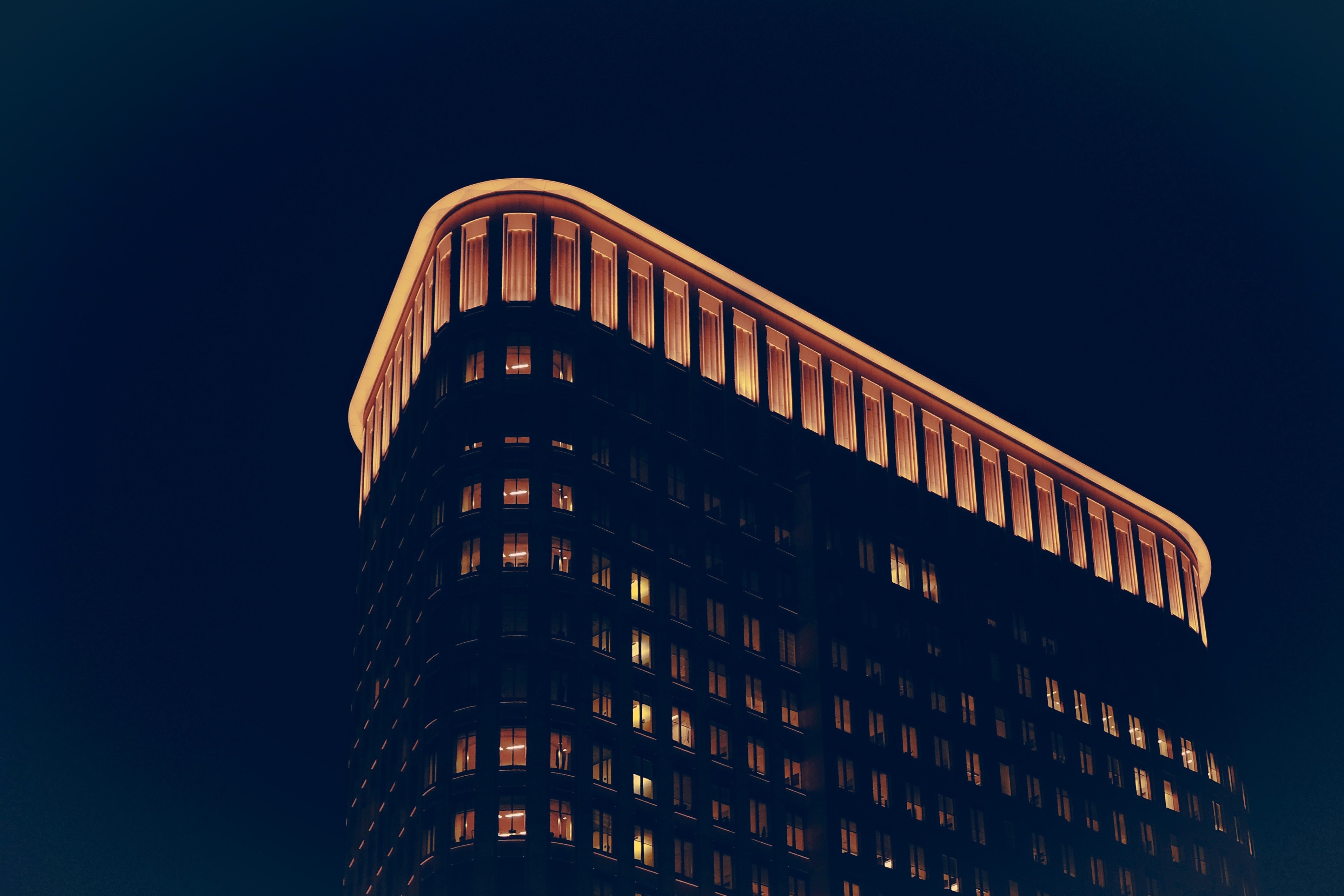 Curved building illuminated at night HD Wallpaper