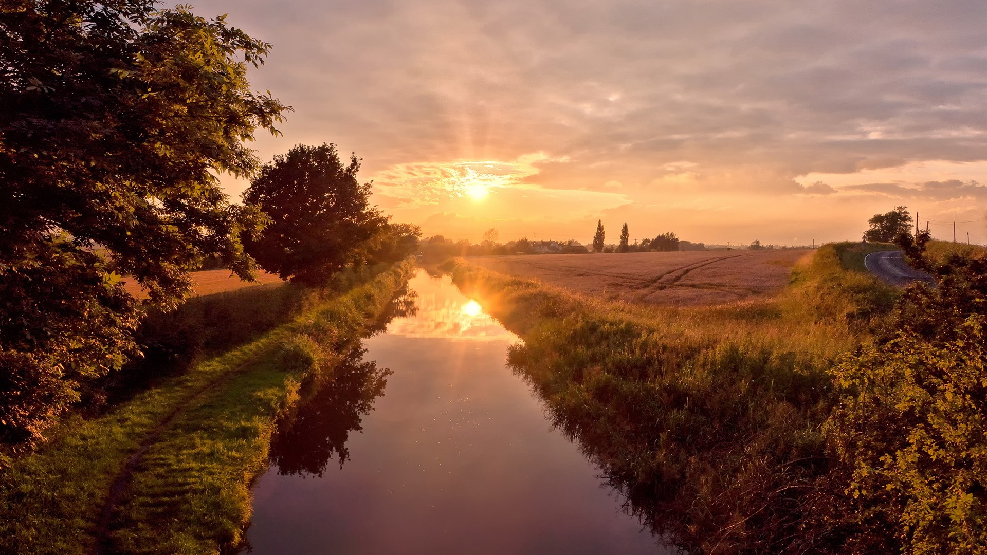 Canal at sunset with fields and road HD Wallpaper