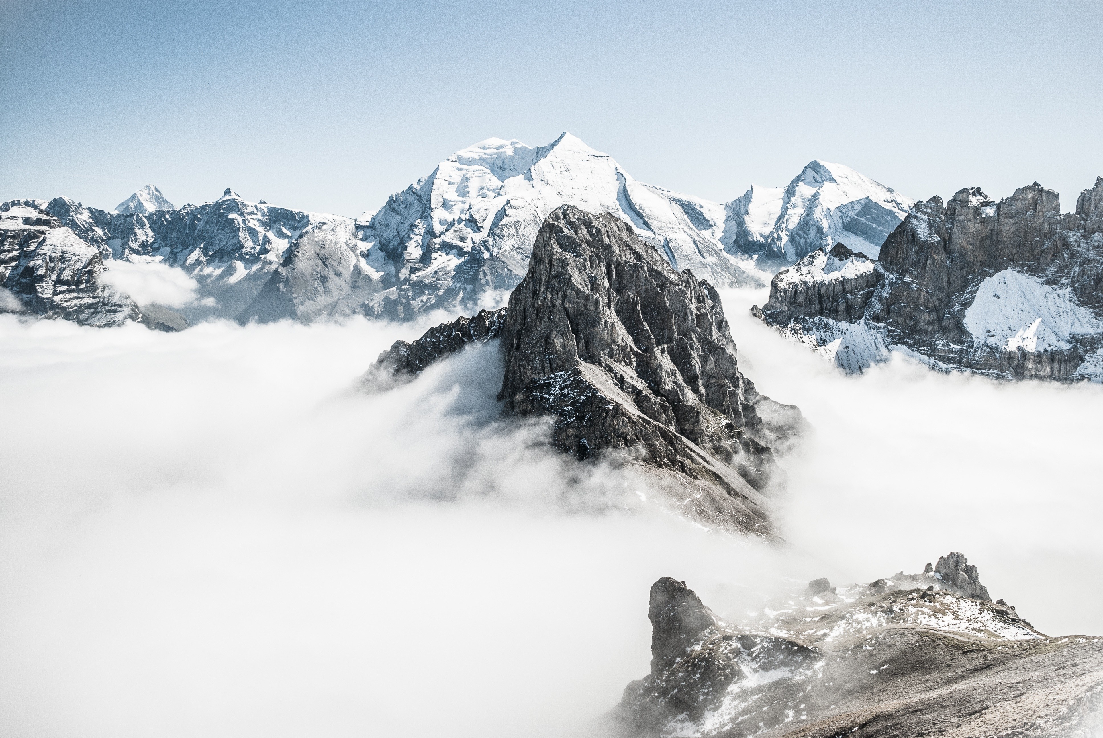 Snow-capped mountains above clouds in the Alps HD Wallpaper