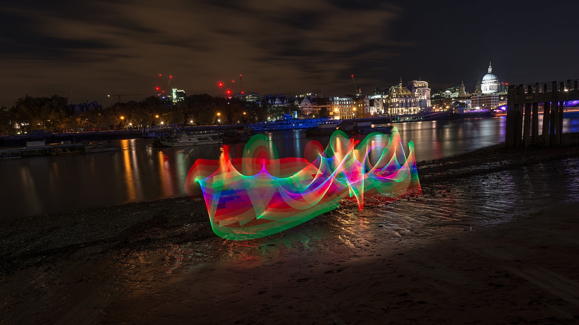 Light painting on the Thames river at night with London cityscape HD Wallpaper