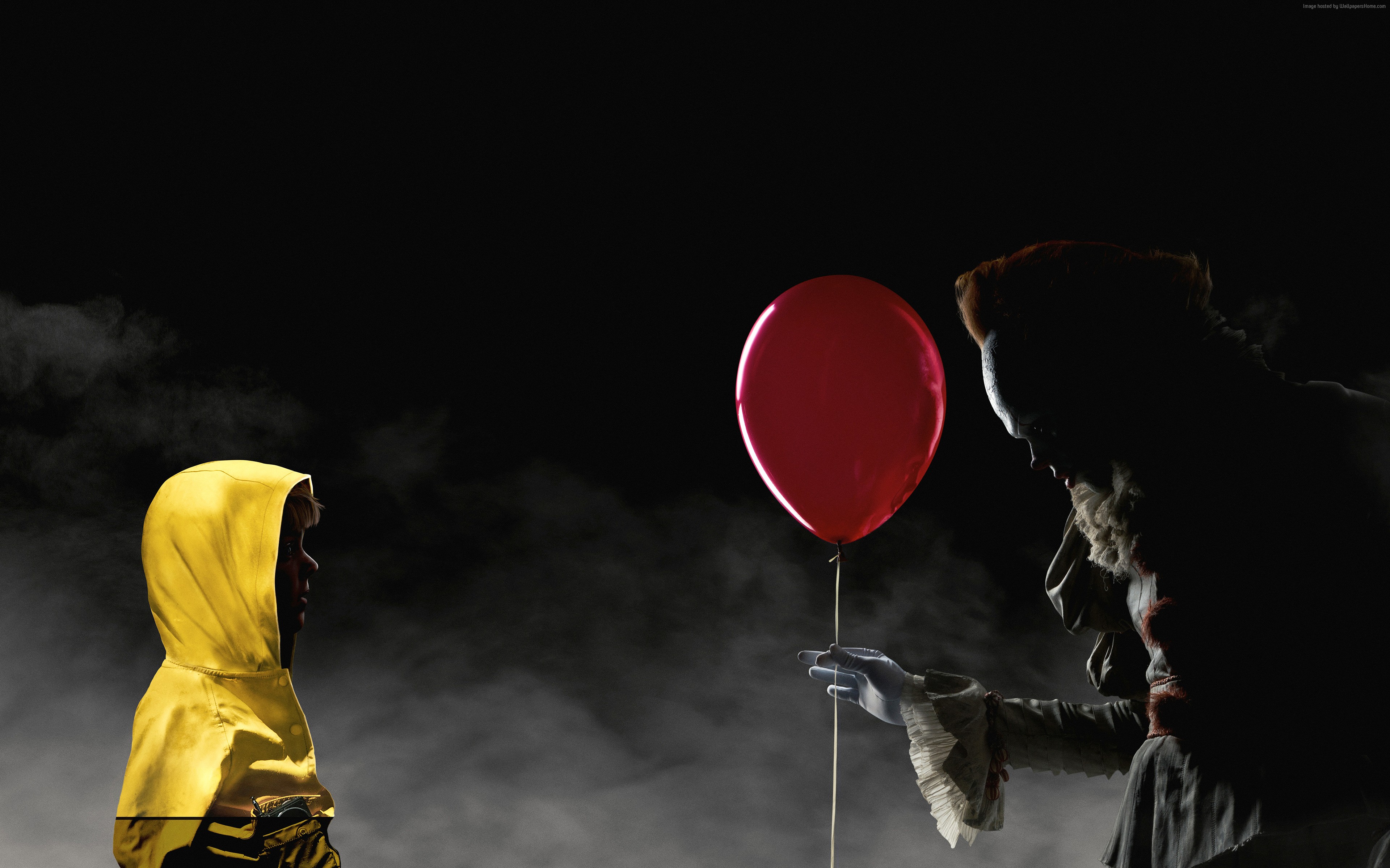 Pennywise the Dancing Clown from It offers a balloon to a child HD Wallpaper