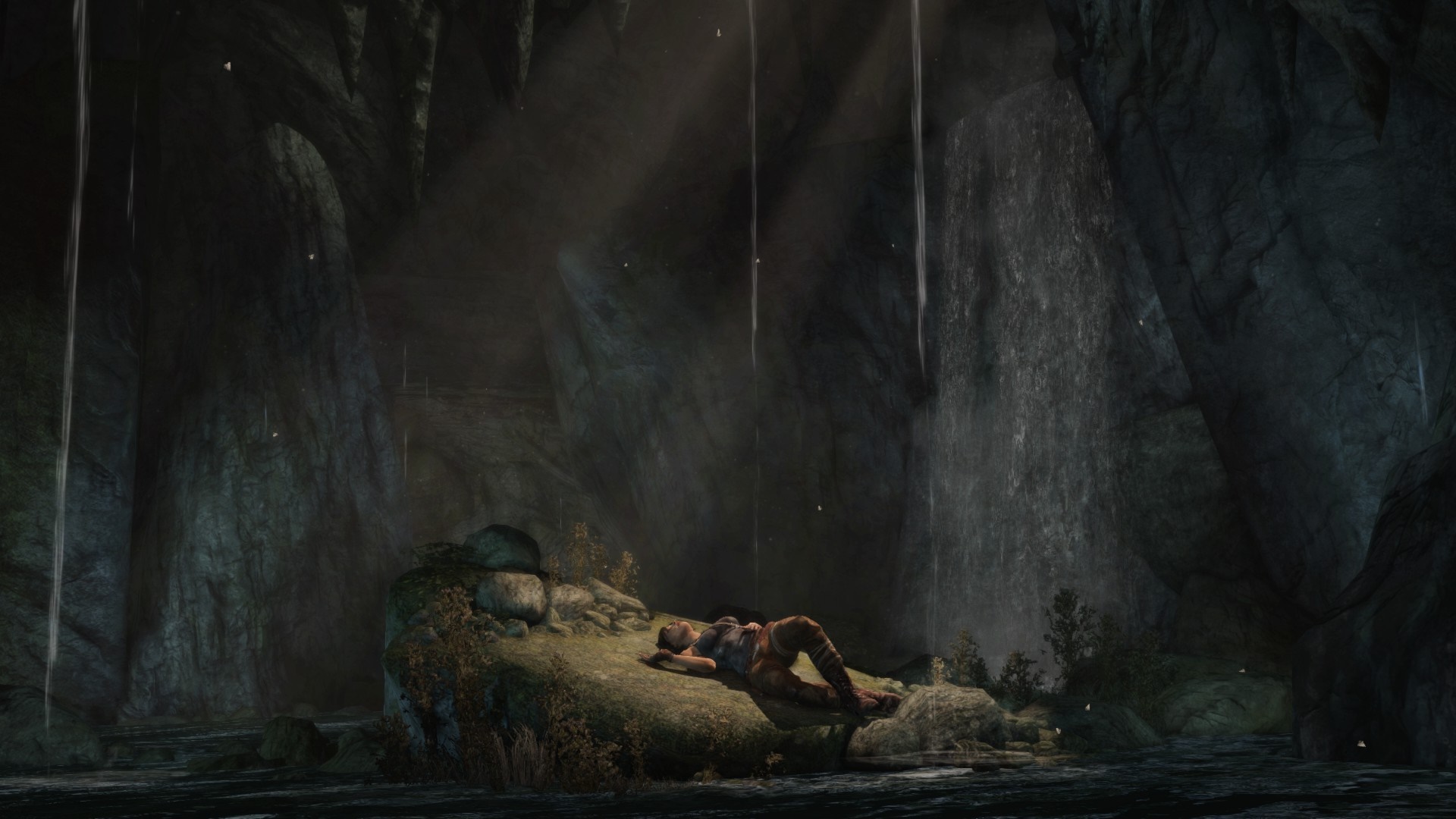 Lara Croft resting in a dark cave with waterfalls HD Wallpaper