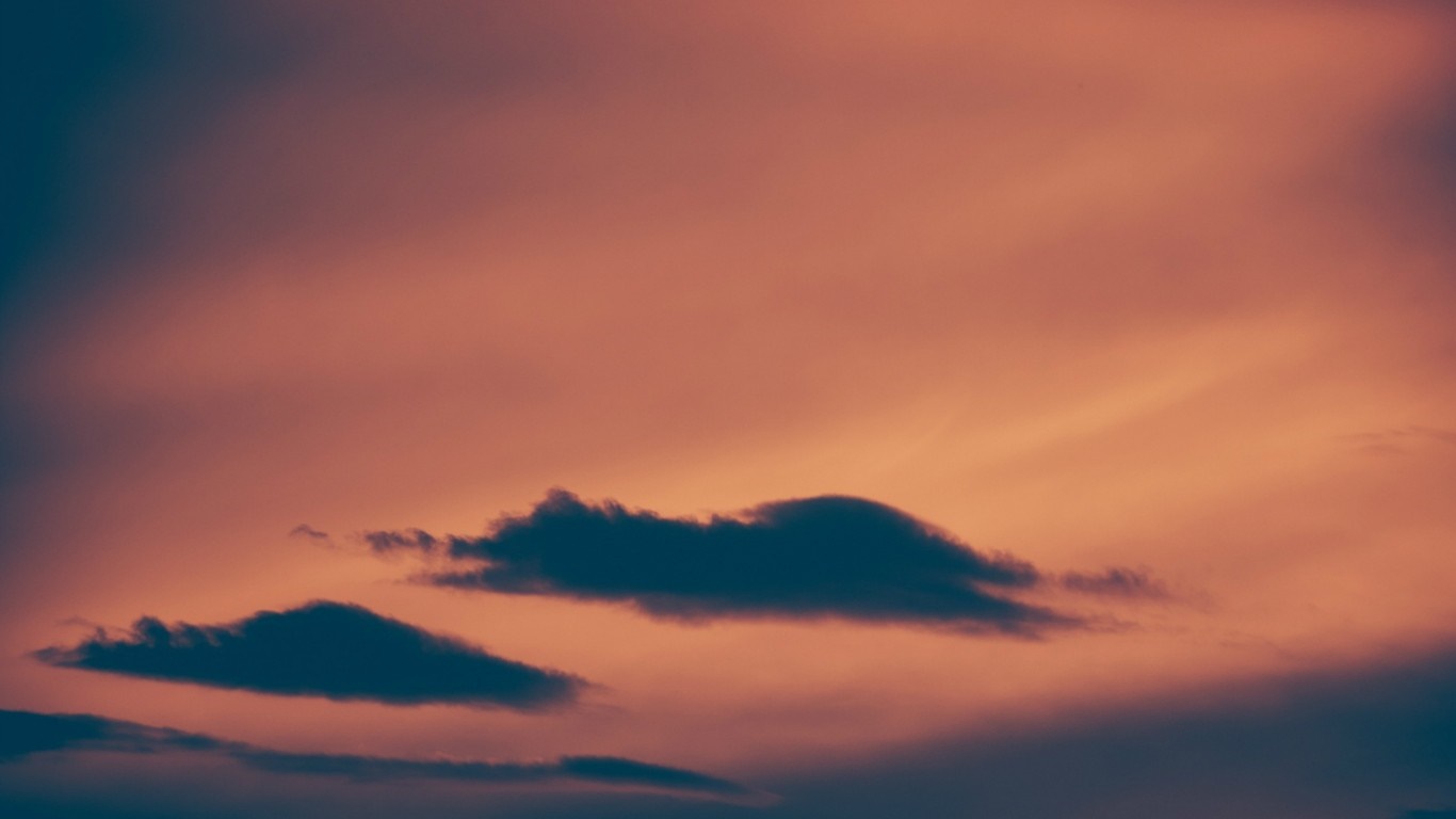 Dark clouds against a sunset sky HD Wallpaper