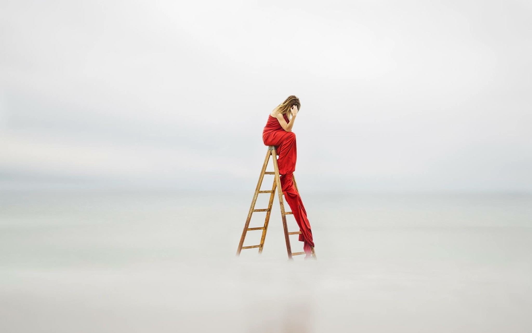 Woman in red dress sitting on a ladder HD Wallpaper