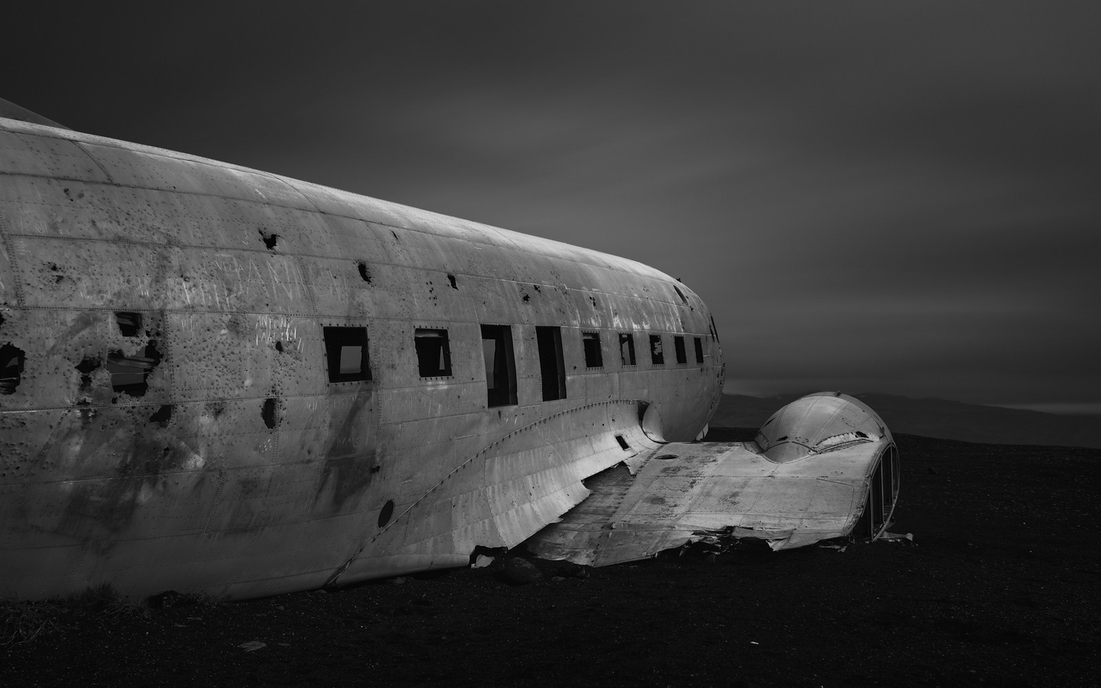 Abandoned airplane wreck on a dark landscape HD Wallpaper