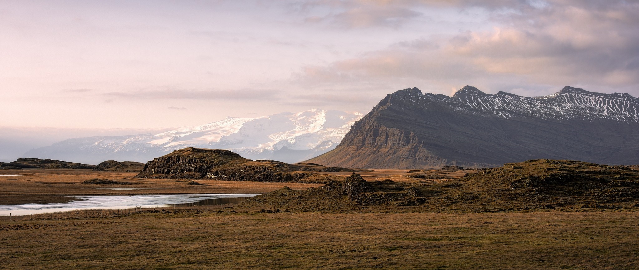 Mountain range with snow and river in Iceland HD Wallpaper