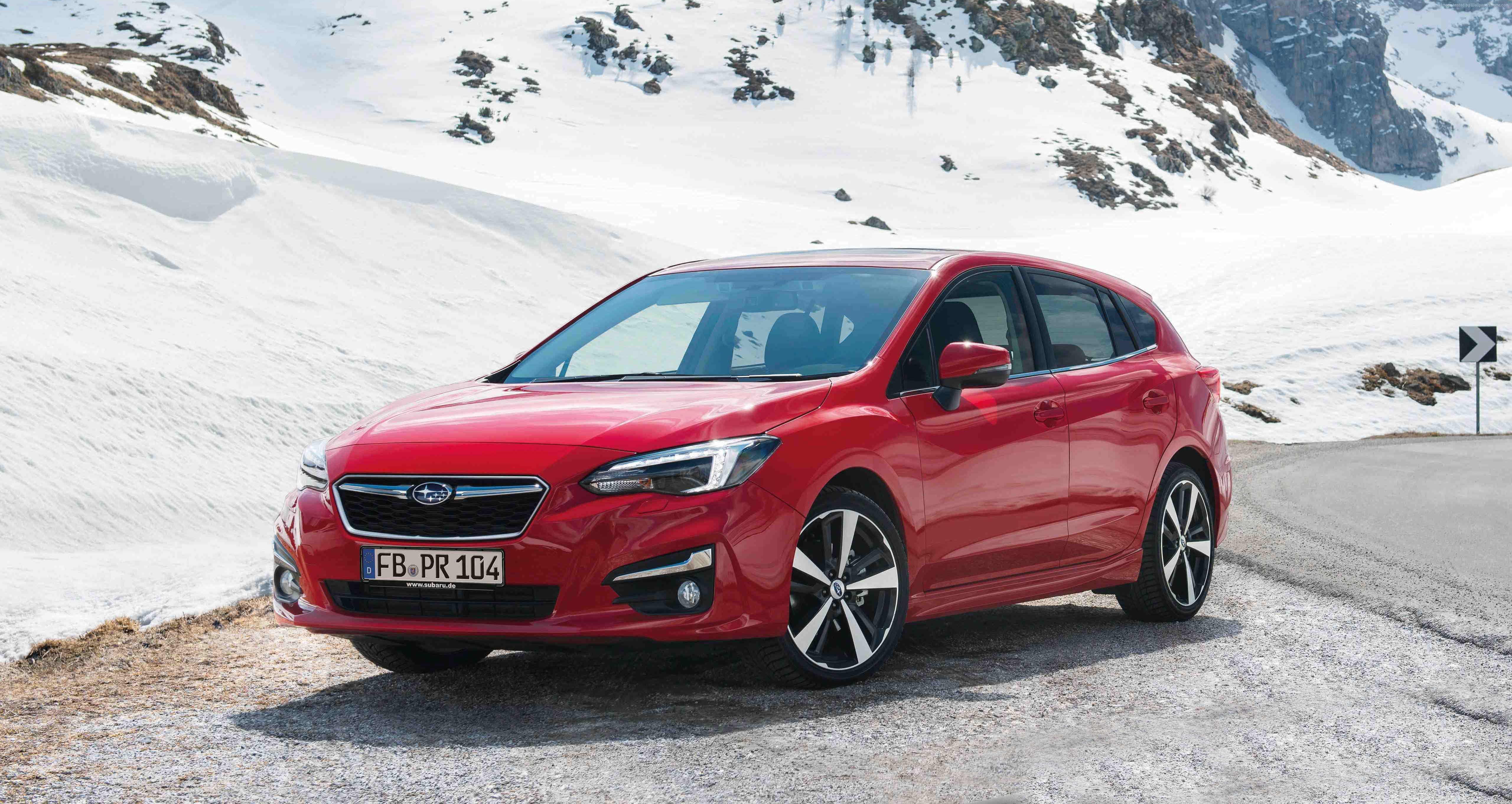 Red Subaru Impreza 5-door hatchback in snowy mountains HD Wallpaper