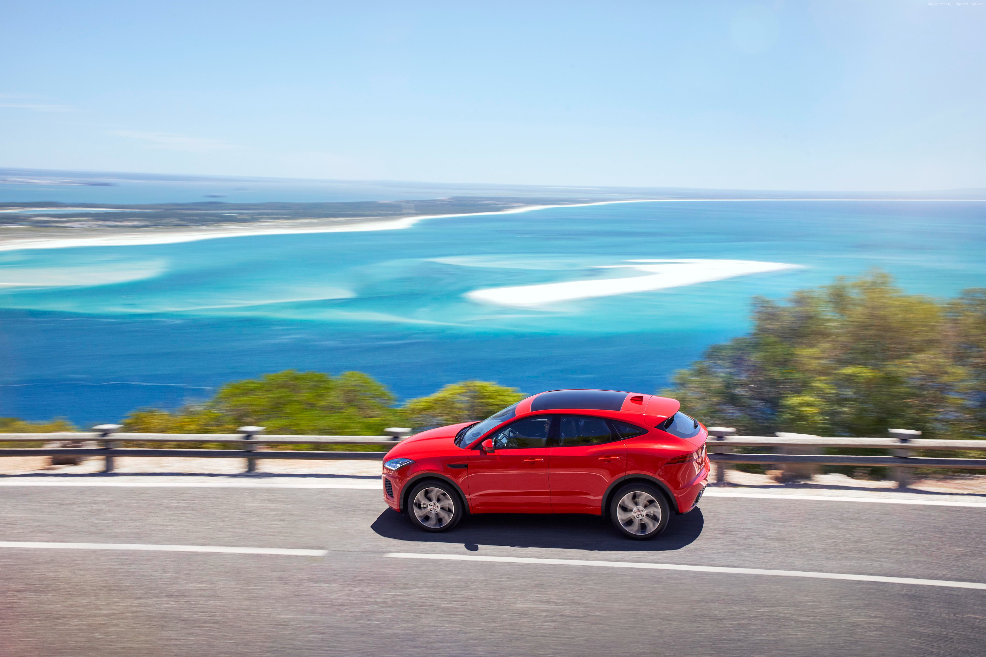 Red Jaguar E-Pace driving on coastal road HD Wallpaper