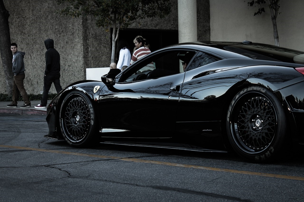 Black Ferrari 458 Italia with people on street HD Wallpaper