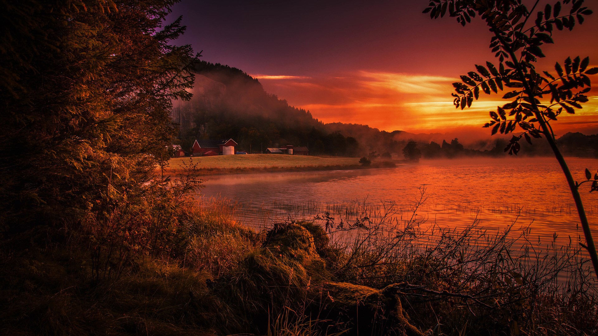 Farm buildings by a misty lake at sunset HD Wallpaper