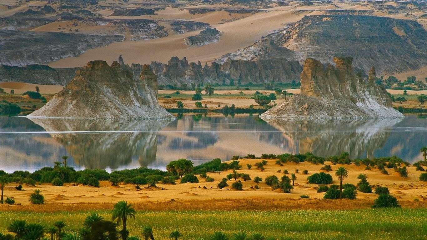 Desert landscape with rock formations and a lake HD Wallpaper