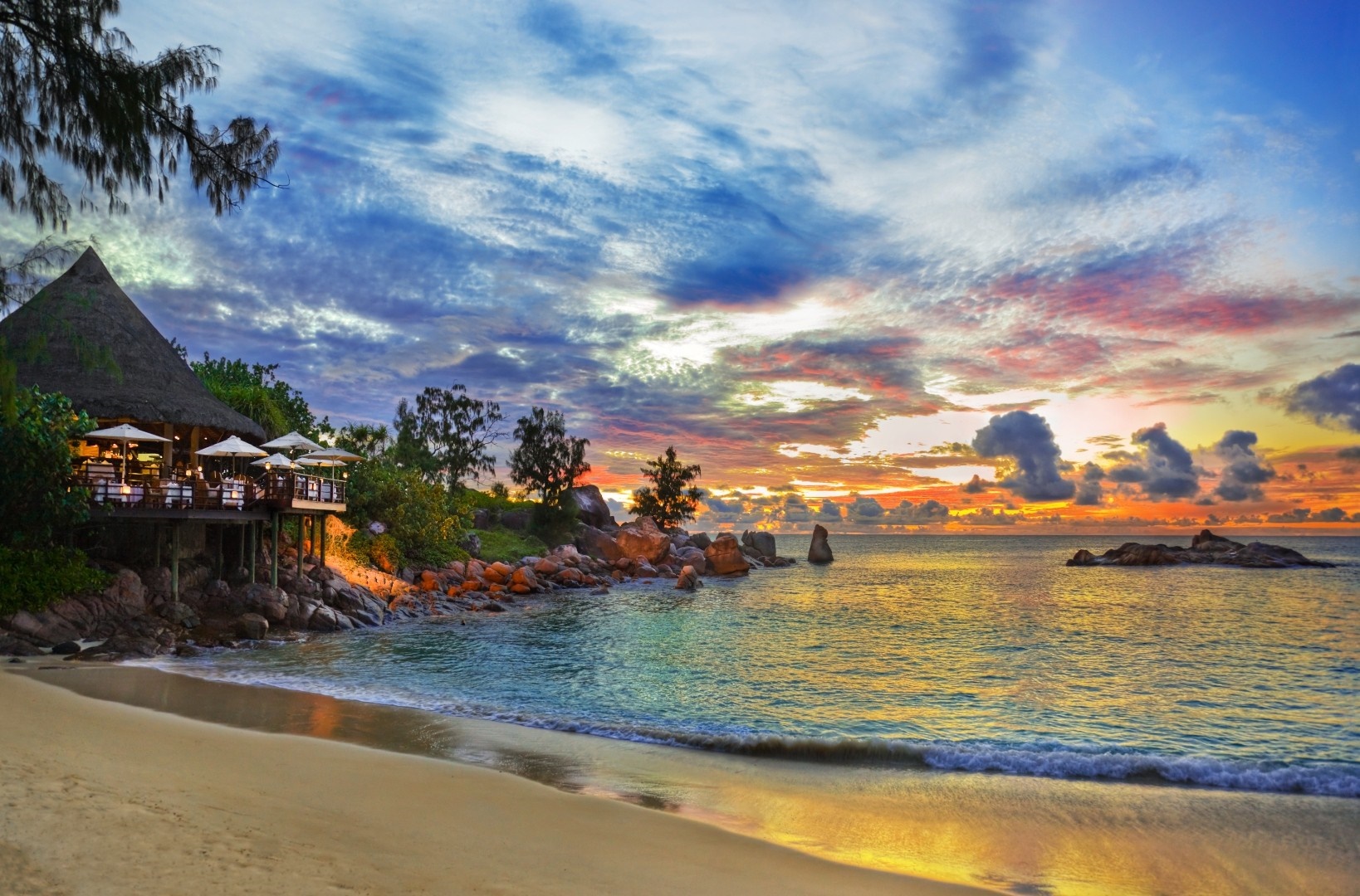 Tropical beach restaurant at sunset with ocean view HD Wallpaper