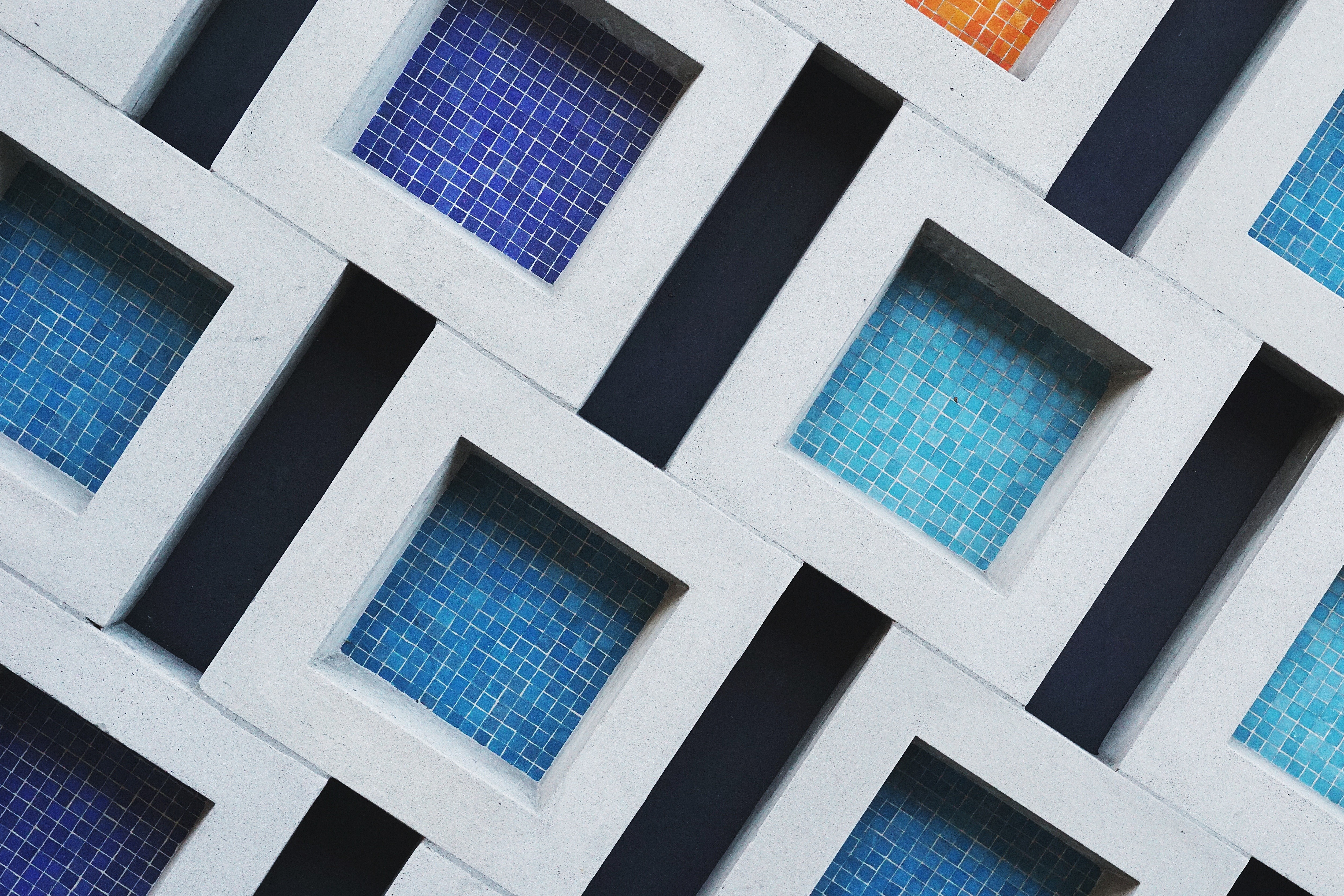 Abstract pattern of blue and orange tiles in concrete frames HD Wallpaper