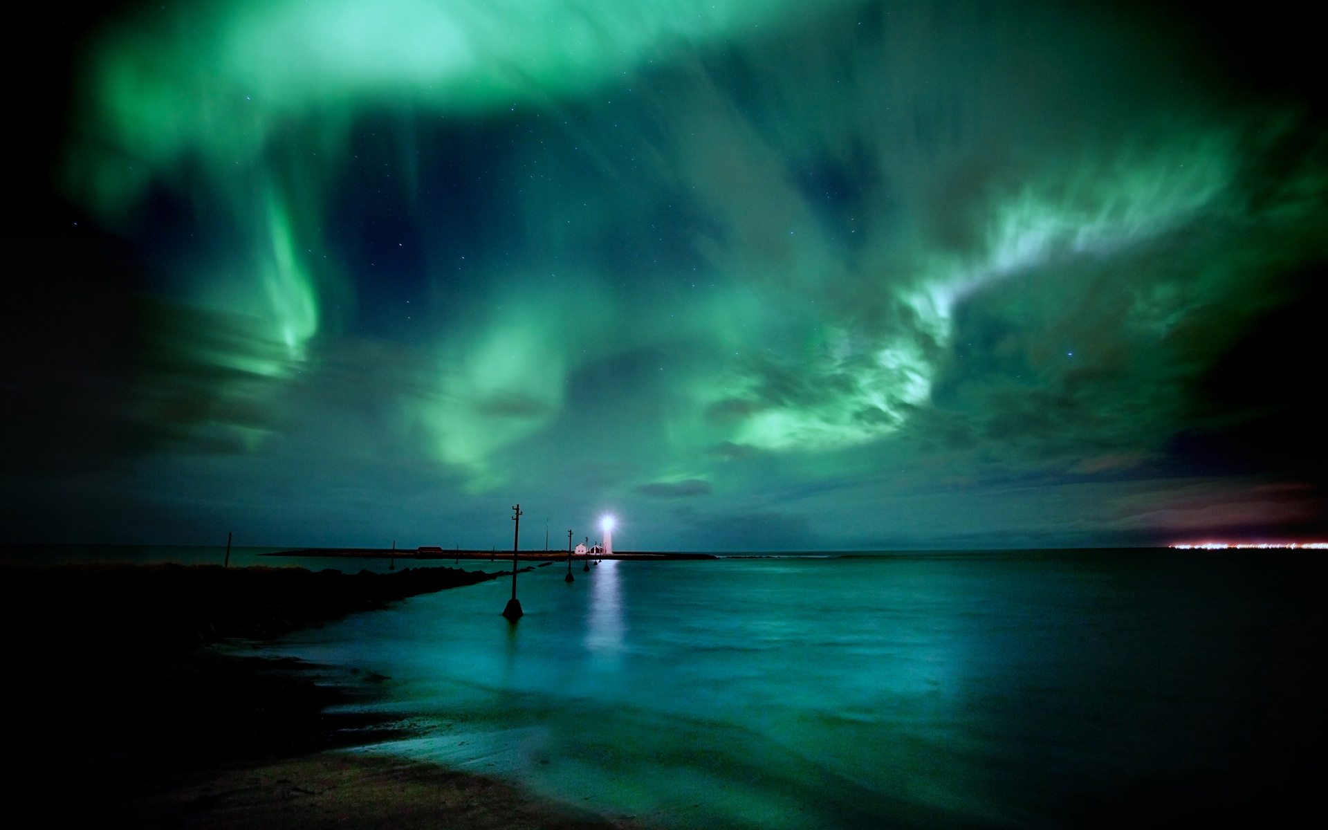 Aurora Borealis over a lighthouse and sea at night HD Wallpaper