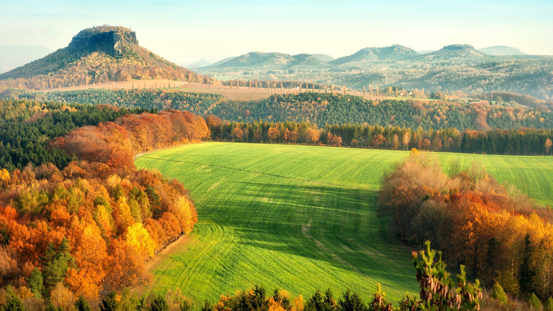 Autumn landscape with rolling hills and a prominent mesa HD Wallpaper